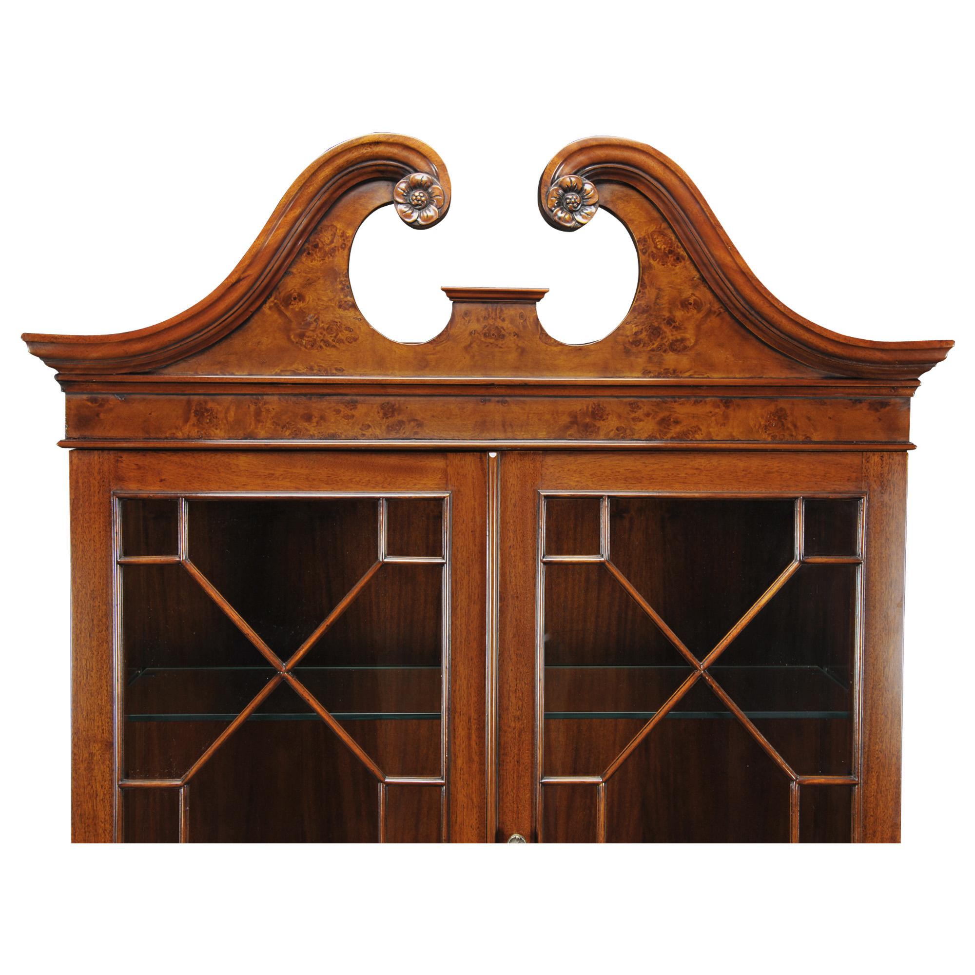 This Burled Secretary Desk from Niagara Furniture has all the features of an antique original. Made of high quality mahogany solids and burled veneers, the bookcase has a lovely swan neck pediment. There are two glass shelves in the upper section of