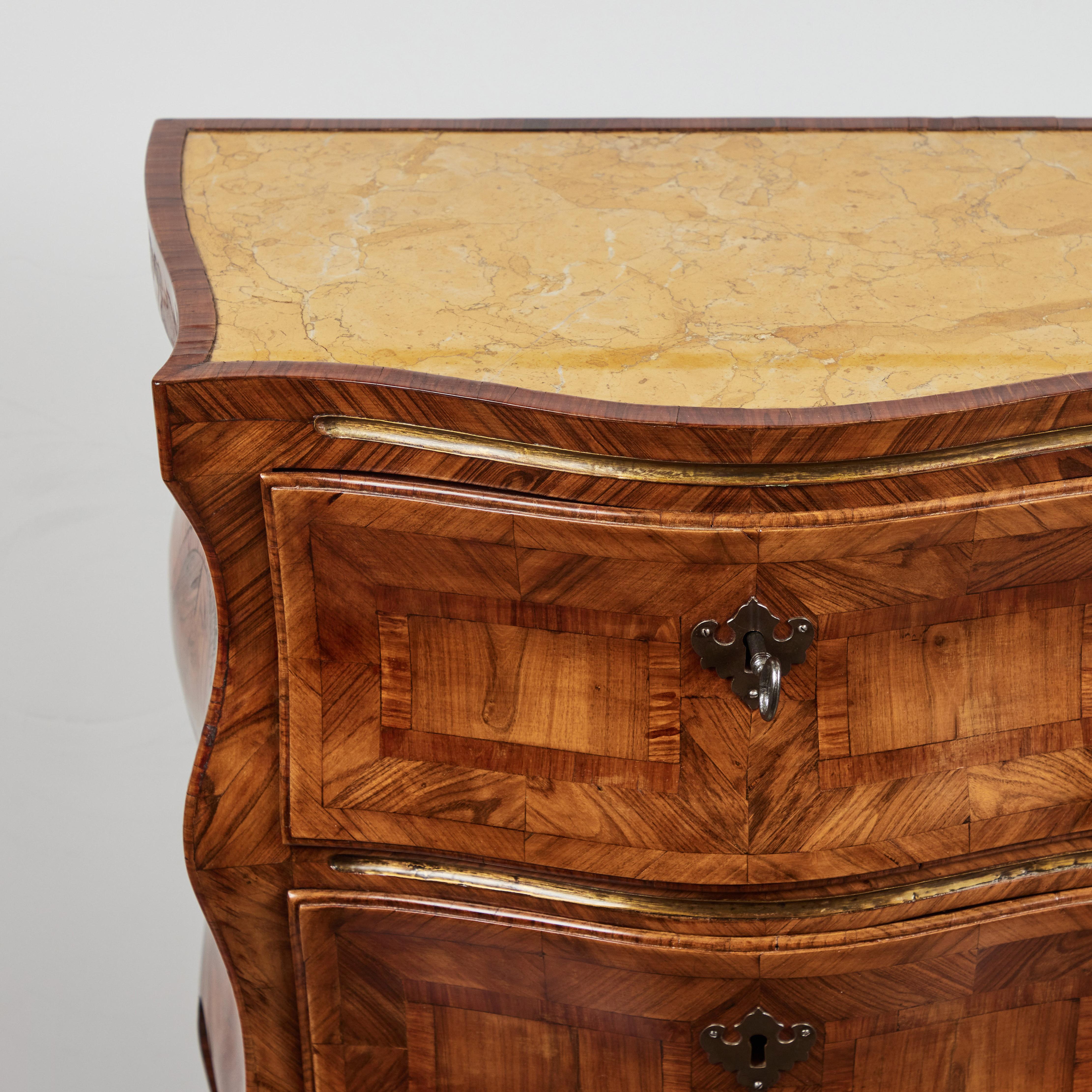 Beautiful burled walnut veneered and inlaid 2 drawer commodino. Beautiful movement. Patinated bronze locks and sabots. Parcel gilt lines. Inset sienna marble top. From the area of Sicily.