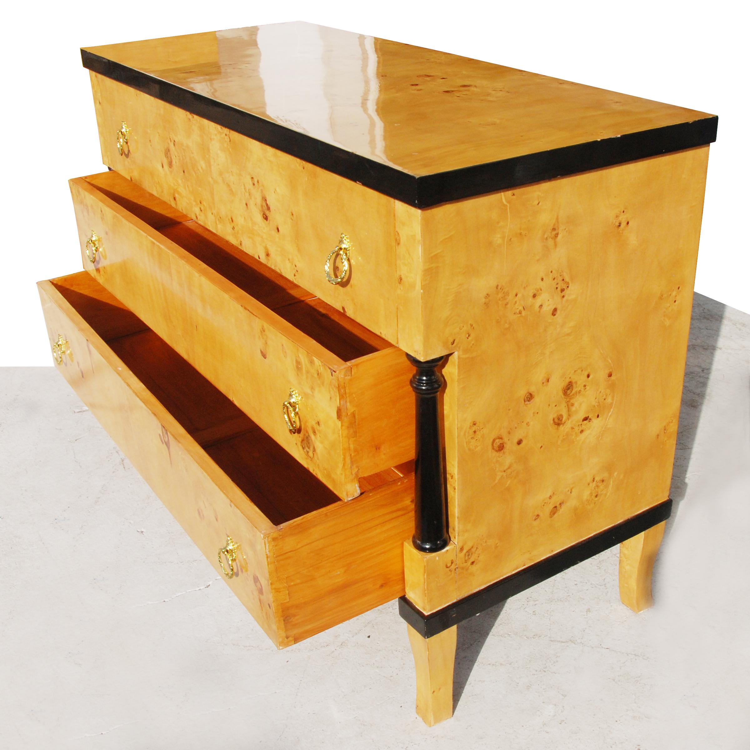 Burled wood Art Deco style dresser with ebonized trim. Three drawers and brass ring pulls.