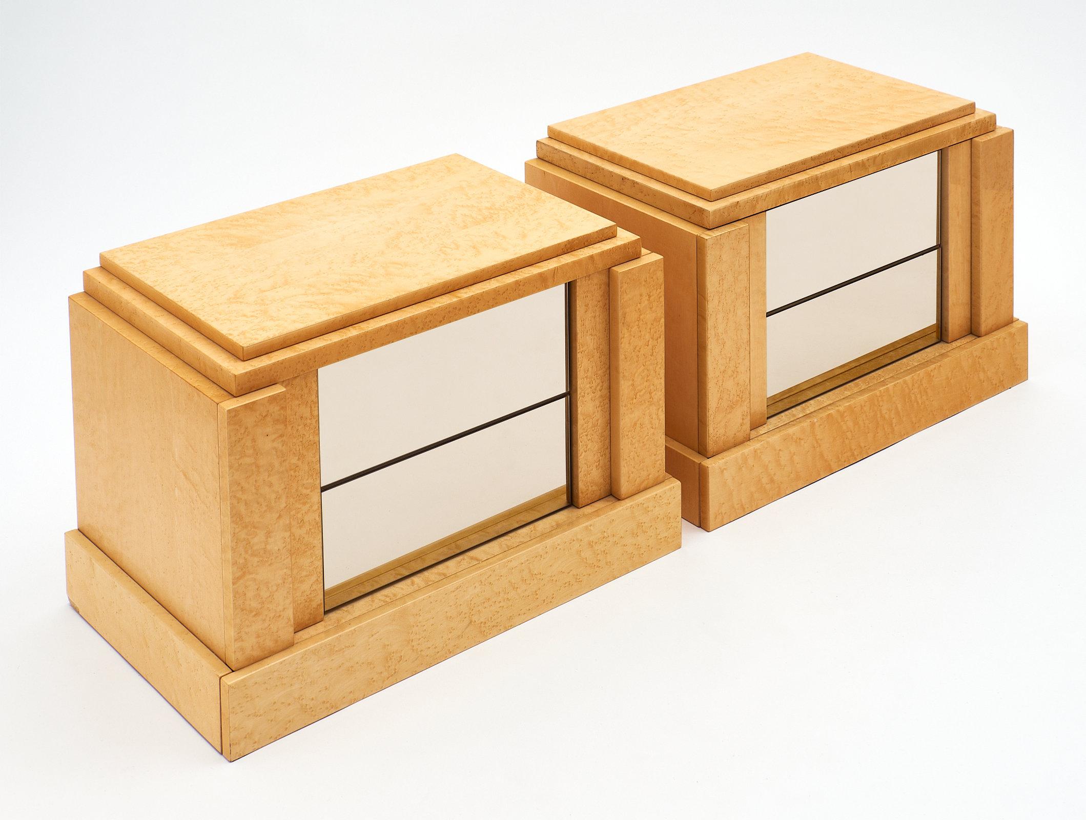 Modernist burled wood side tables made of maple and featuring smoked glass drawer fronts. We love the classic feel of this pair. They are finished with a high gloss lacquer. Each has two drawers with a push-open mechanisms in excellent working