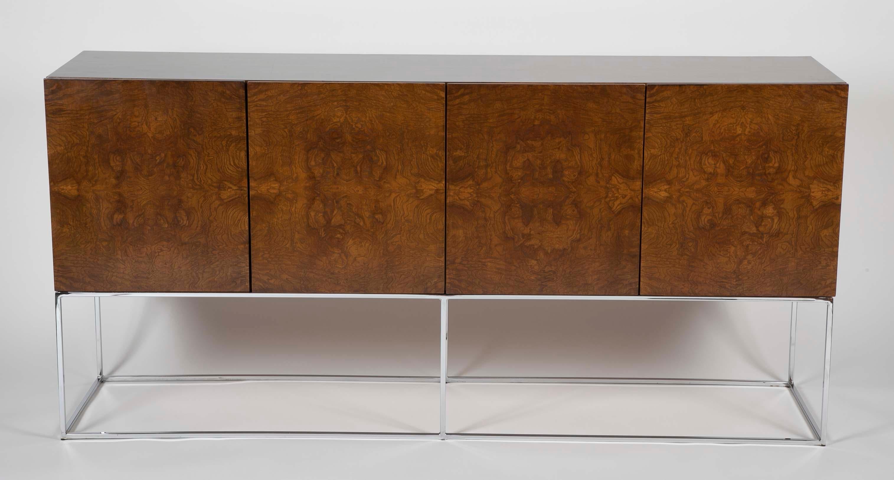 A four door midentury burled wood sideboard on chrome base by Milo Baughman.