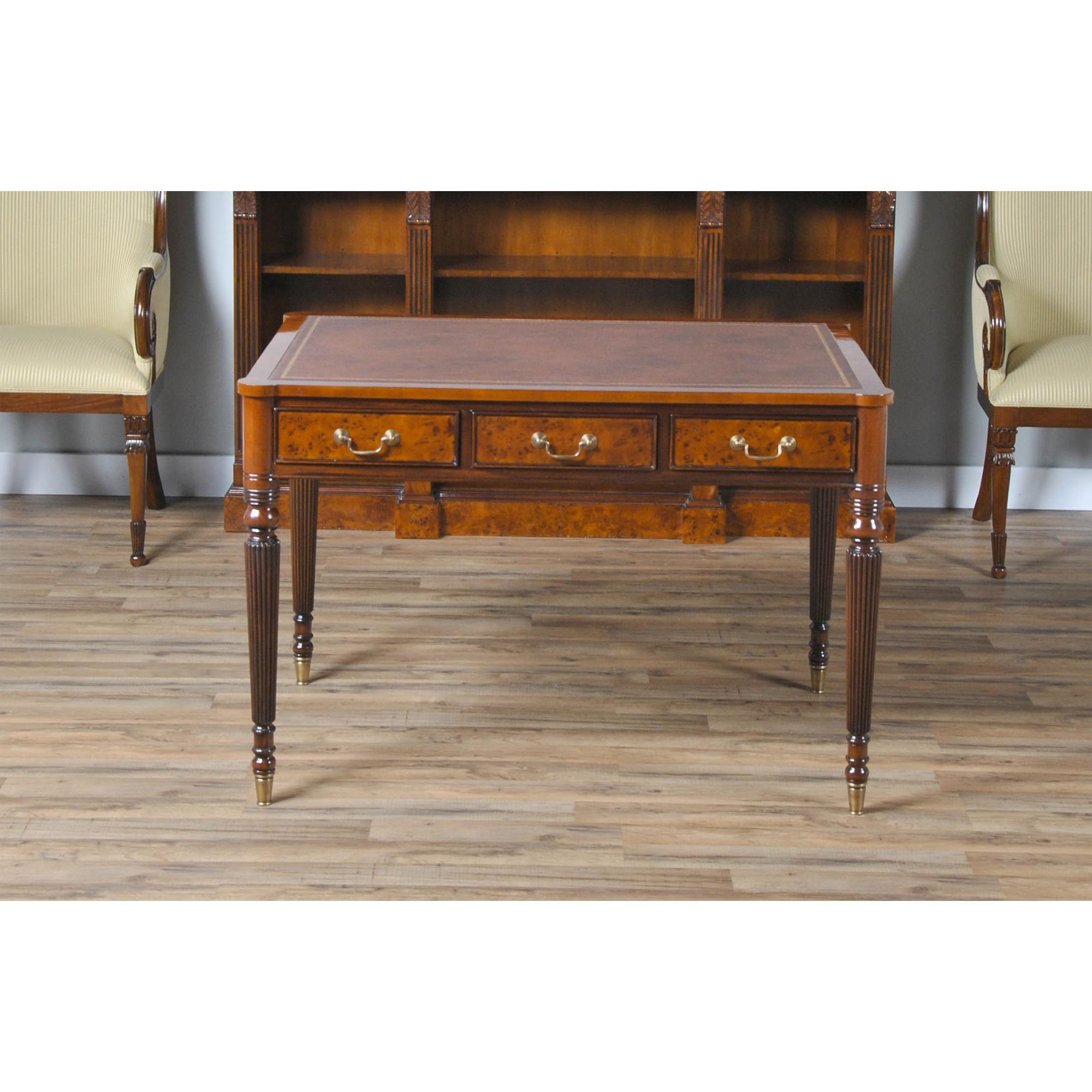 An elegant Burled Writing Table from Niagara Furniture which is perfect either at home or in the work office. Features include a large brown leather tooled top, made from full grain genuine leather, a flat edge profile with cookie cutter corners,