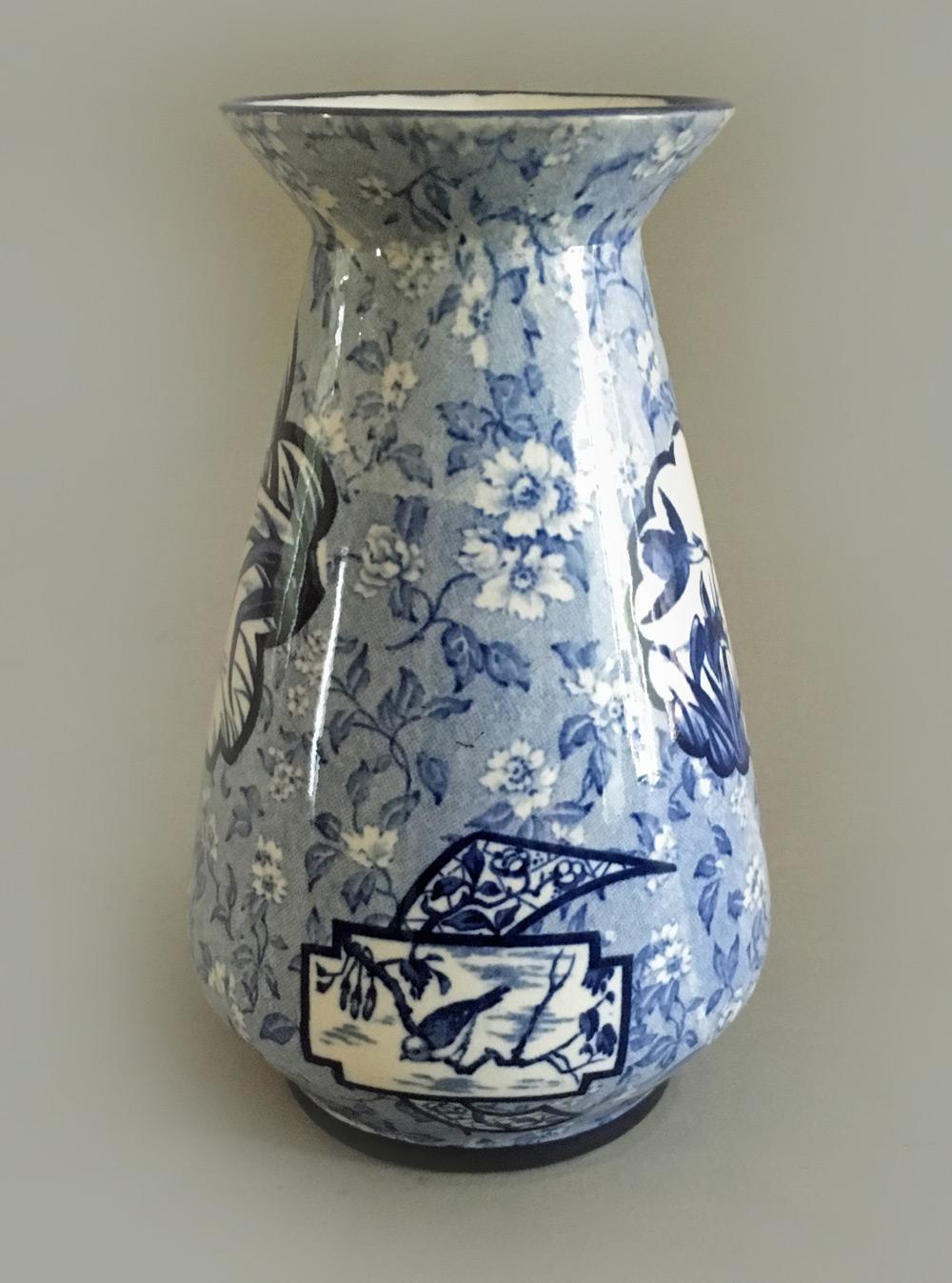 A vintage small blue and white Burleigh (Burgess & Leigh) Burslem vase, the baluster shaped vase and flared neck decorated with several cartouche shapes enclosing birds against a pale blue calico background. The bottom marked Burleigh Ware, Burslem