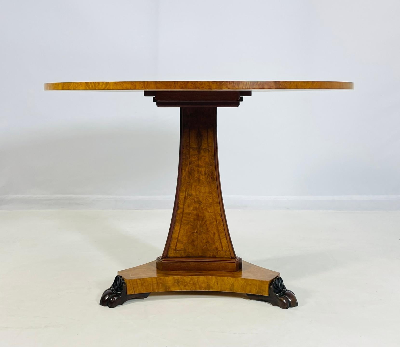 Vintage Dining or center table designed and manufactured in the United States in 1992, signed FW,  CHXI and dated 1992.

The table has a beautiful burlwood top and base, the base is adorned with stunning lion paws made in solid bronze, the top has a