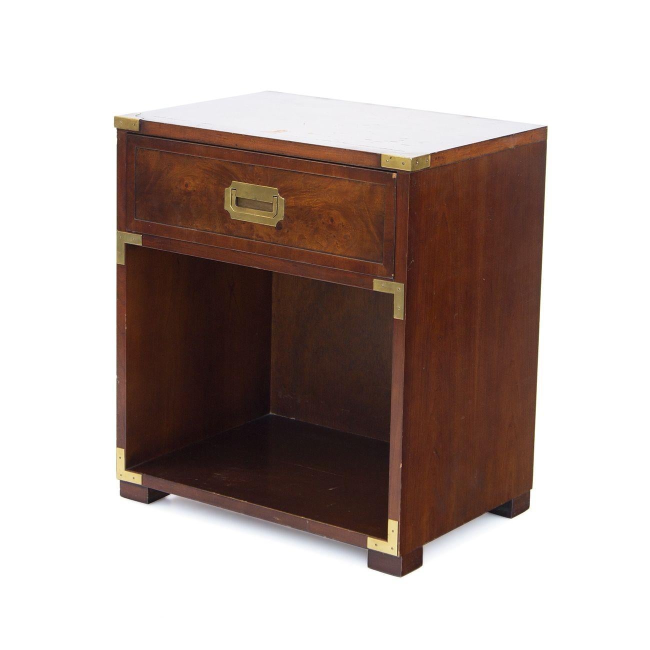 USA, 1970s
Burlwood campaign nightstand made by Hekman. Single drawer for storage, brass campaign hardware, quality solid core construction with luxurious burlwood. 
CONDITION NOTES: Top finish has wear as pictured- areas where the lacquer finish