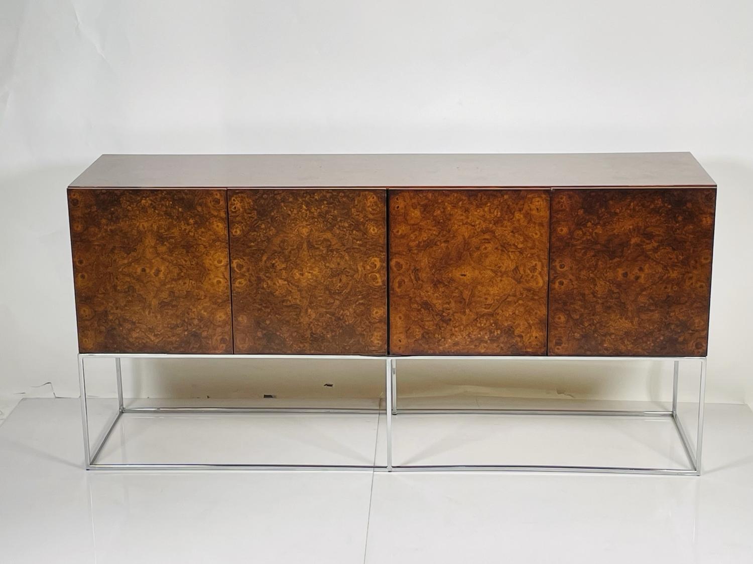 Milo Baughman for Thayer Coggin Burl Wood Sideboard, the rectangular top with burl wood veneer and four hinged panel doors opening to a fitted interior, raised on a squared chrome base.
 
 Dimensions: 34.75 inches high x 72 inches wide x 18 inches