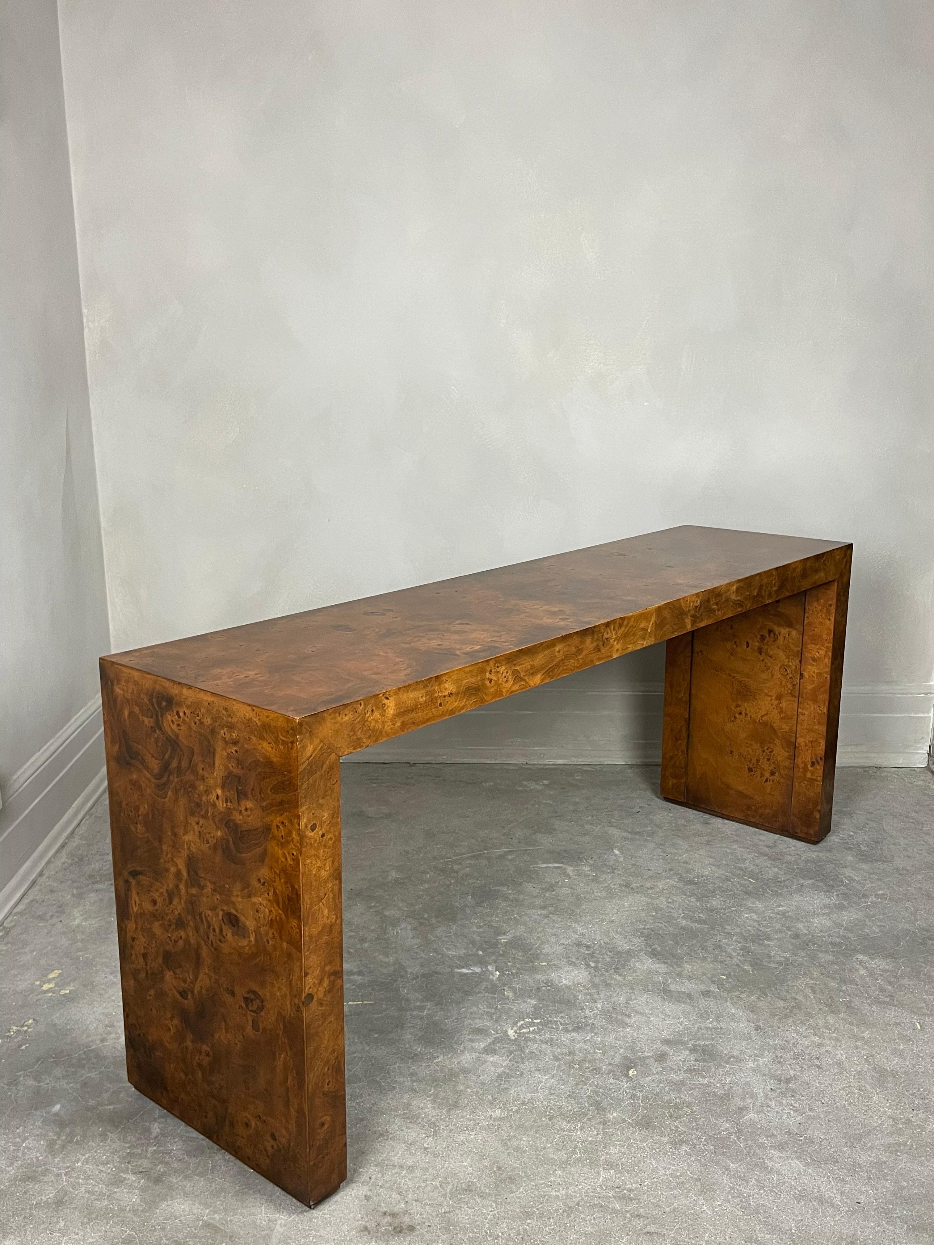 Gorgeous waterfall burl wood table attributed to Milo Baughman manufactured by Heckman Furniture. A sleek and sophisticated design perfect for a post modern or MCM home. Features long slabs of burl wood veneer which is rare to find in modern day