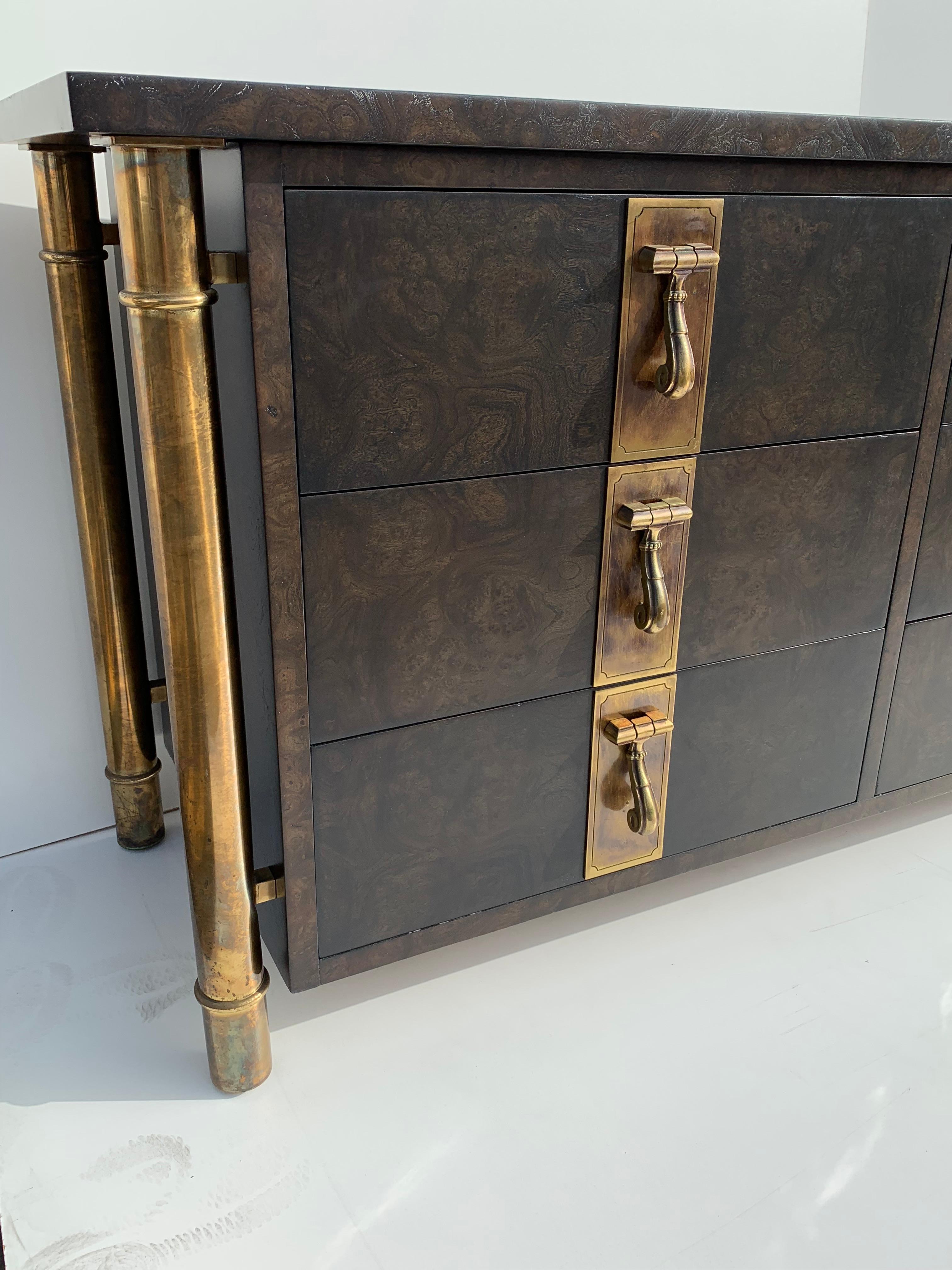 Ebonized burl wood Mastercraft nine-drawer dresser with antique brass hardware and legs.