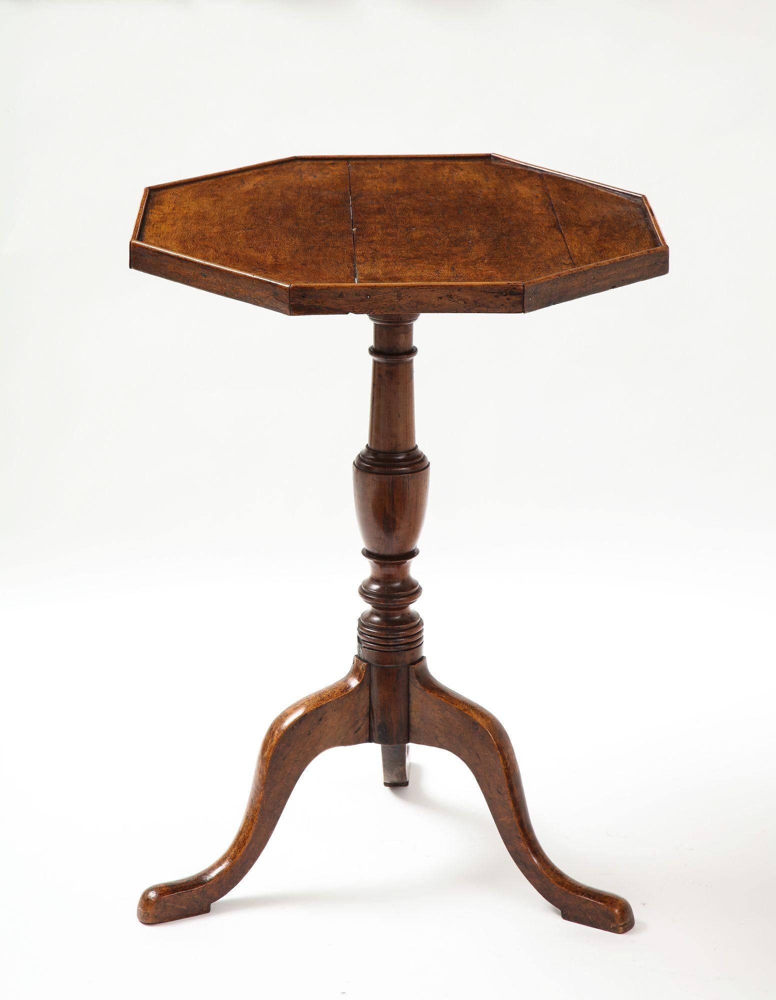 Fine English country octagonal burlwood table, the solid burl top with raised border over turned shaft and standing on tripod legs with well shaped slipper feet, the whole possessing good rich color and patination.