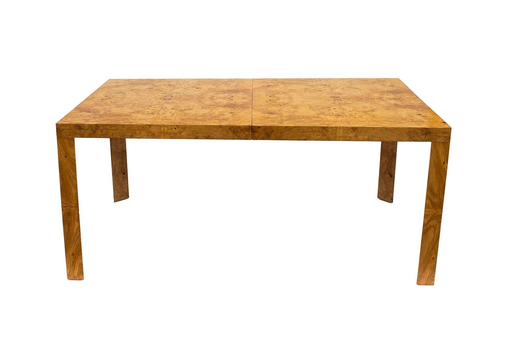 USA, 1970s
A substantial vintage burl dining table with triangular legs and two leaves. The geometric design of the legs lends a nice complement to the clean-lined parsons style and bookmatched burlwood. Slim profile legs and made to Dunbar quality.