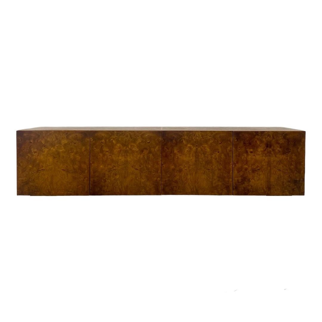 Milo Baughman for Thayer Coggin Burl Wood Sideboard, the rectangular top with burl wood veneer and four hinged panel doors opening to a fitted interior, raised on square wooden legs. The original chrome base for this piece is missing and have been