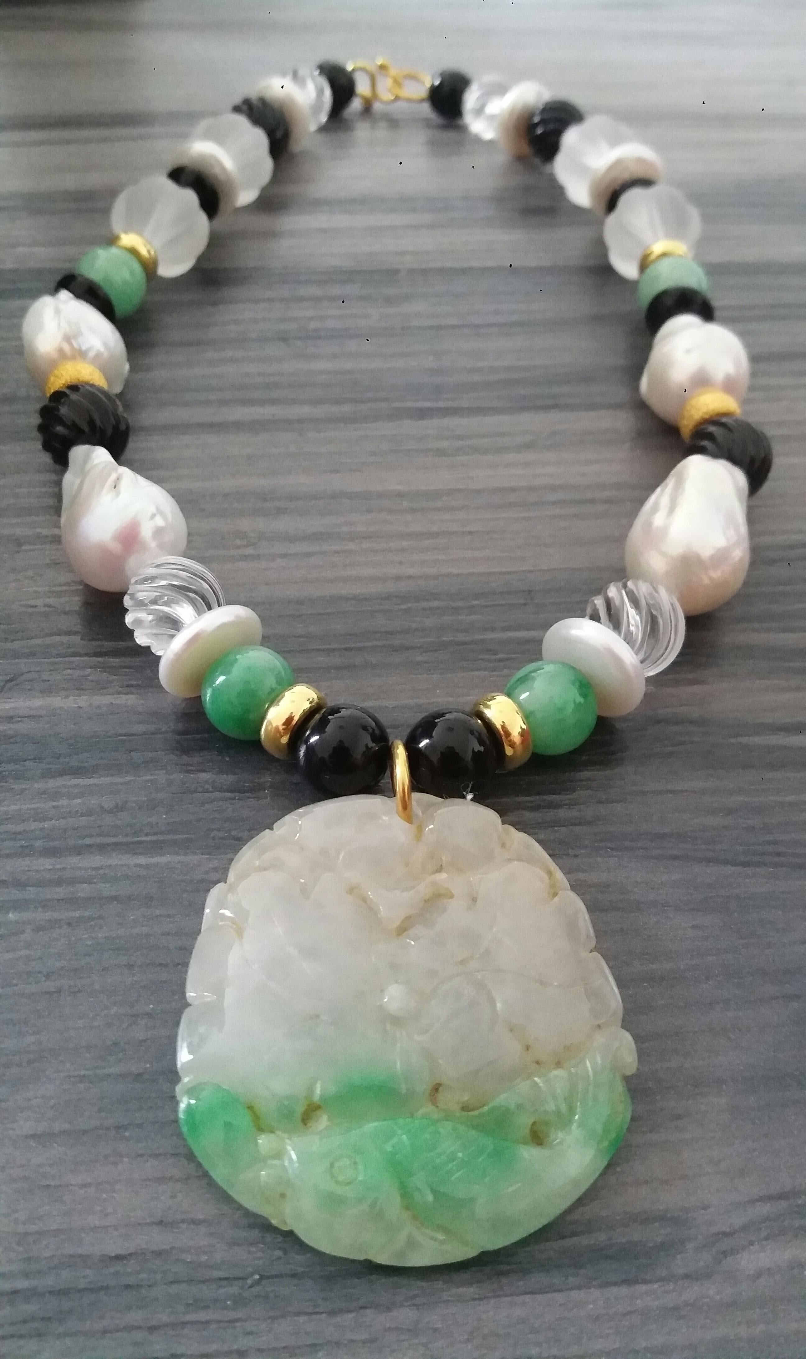 Unique and classic Necklace composed of big size Baroque Pearls, Green Burma Jade 10 mm spheres , Faceted Quartz, Black Onyx 16 mm diameter, 14 kt Yellow Gold elements, from which hangs a pendant of engraved Green Burma Jade 45x50 mm.
In 1978 our