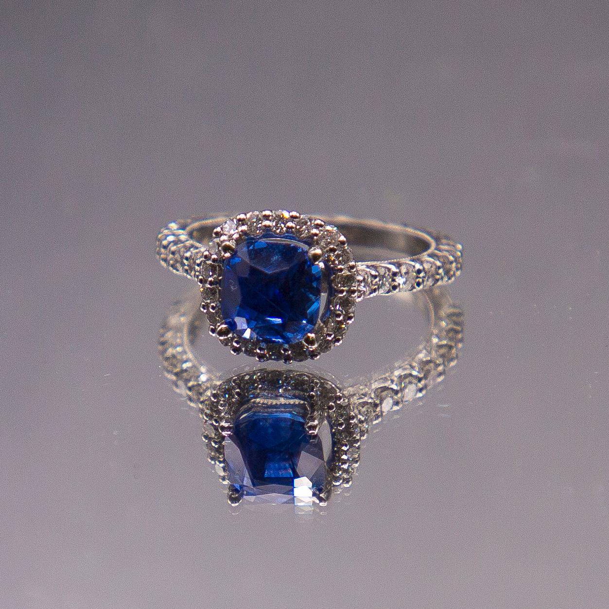 A rare and highly transparent No Heat Burma (Myanmar)  intense blue sapphire weighing 3.32 carats modified cushion cut,  adorns a handcrafted one of a kind engagement ring set in 950 Platinum. Platinum is hand engraved and encrusted with F colour