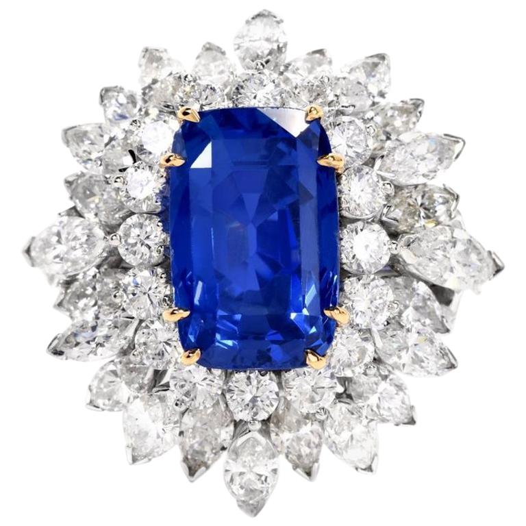 This exquisite sapphire and diamond ring is handcrafted in solid platinum, with an 18-karat yellow gold setting. Showcasing one rare genuine cushion-cut natural GIA lab reported Burma blue sapphire, with no heat, weighing approximately 13.65 carats