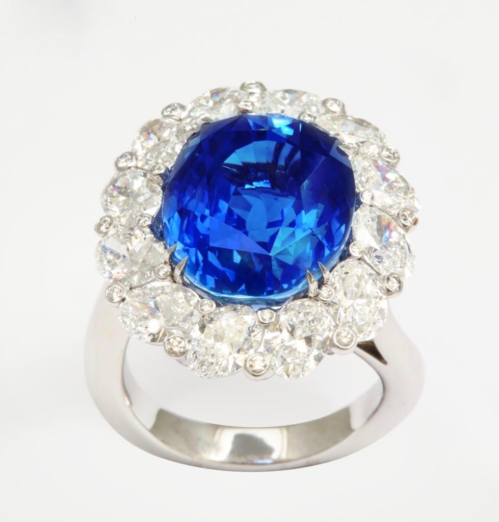 The beauty of ovals is perfectly expressed in this exquisite ring.  
The central oval sapphire (Gübelin certificate Burmese origin, no heat treatment) weighs 15.38cts.
12 oval diamonds are beautifully set on an angle and weigh a total of 3.74cts.
24
