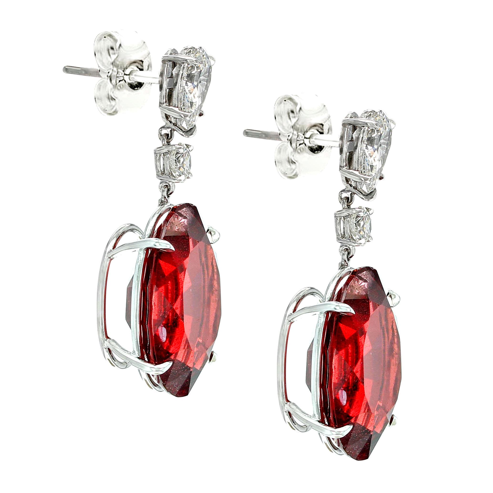 An impressive and rare pair of earrings each set with a large modified oval shape spinel from Burma (Myanmar) hanging from a pear shape and round brilliant-cut diamond setting. The total weight of the two spinels is in excess of thirty-eight carats,