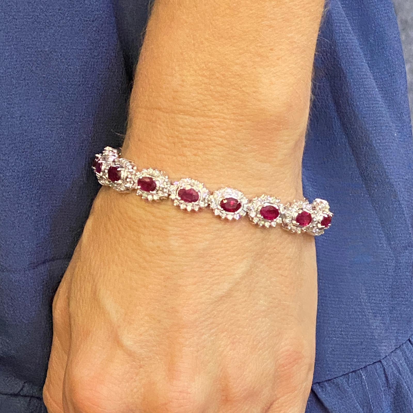Burma ruby diamond bracelet fashioned in 14 karat white gold. The bracelet features 16 beautifully matching oval Burma rubies weighing 10.24 carat total weight, and the vivid red color is called 
