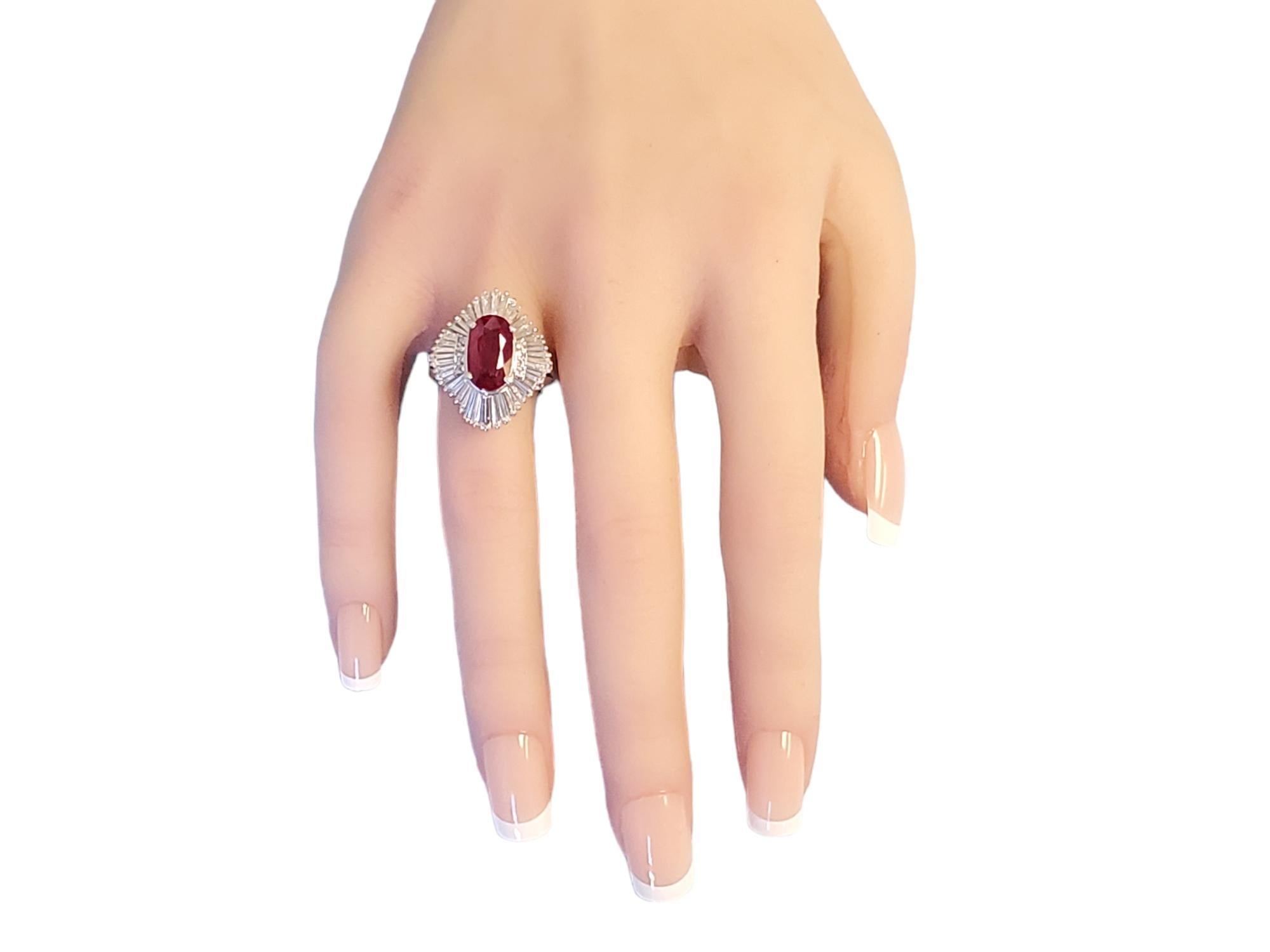 Estate Burma vivid red pigeons blood ruby as stated on GIA report. This is a very rare stone to find, let alone at this price. The long oval is 3.19ct and it faces up more like a 4ct+ stone. 1.78tcw colorless VS diamonds surround the ruby in heavy