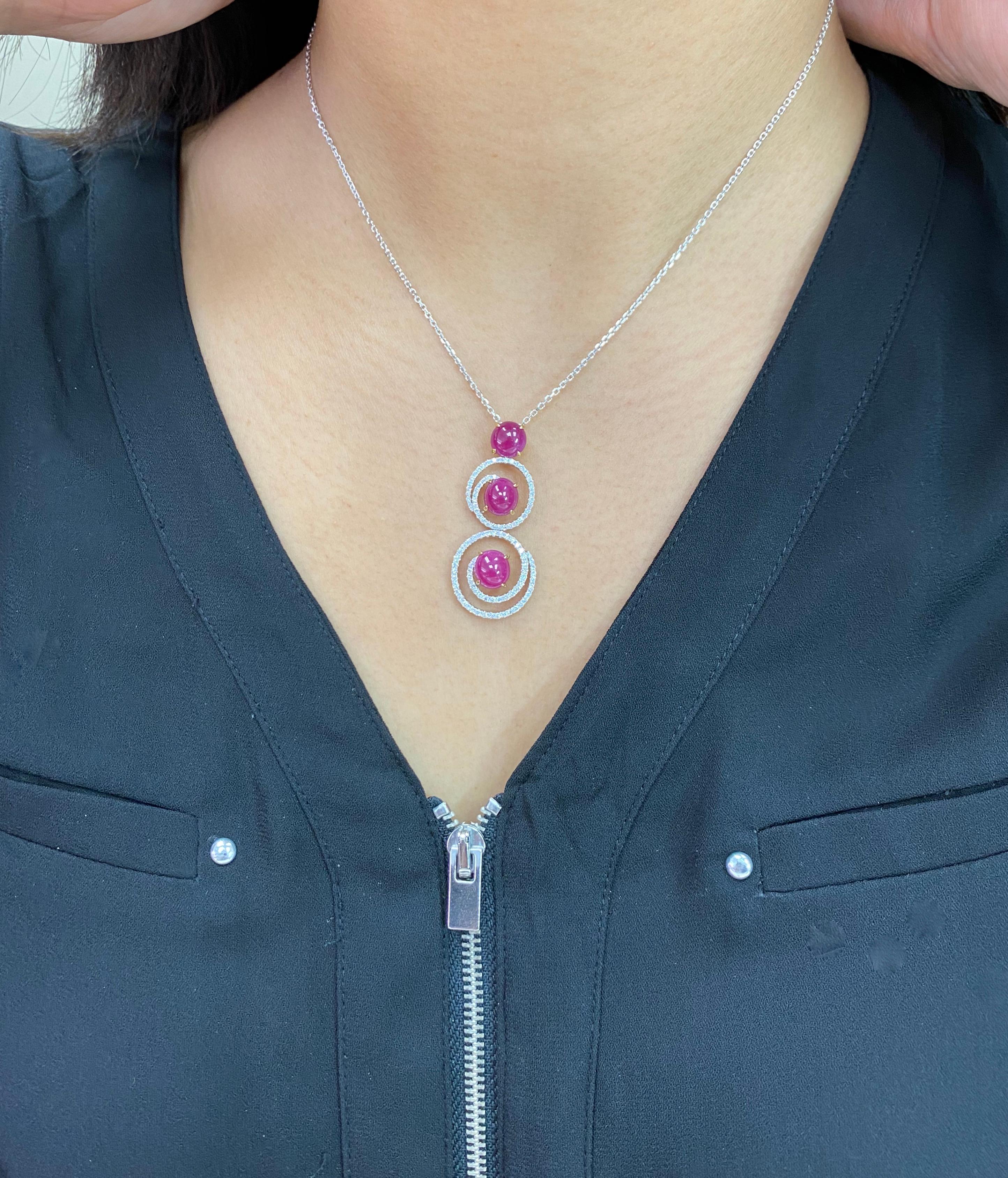 Here is a nice Ruby and diamond pendant necklace. The pendant is set in 18k white gold and white diamonds. There are 3 Burma ruby cabochons totaling 7.05Cts. There are 100 small diamonds totaling 0.67cts in this pendant. The rubies are red in color.