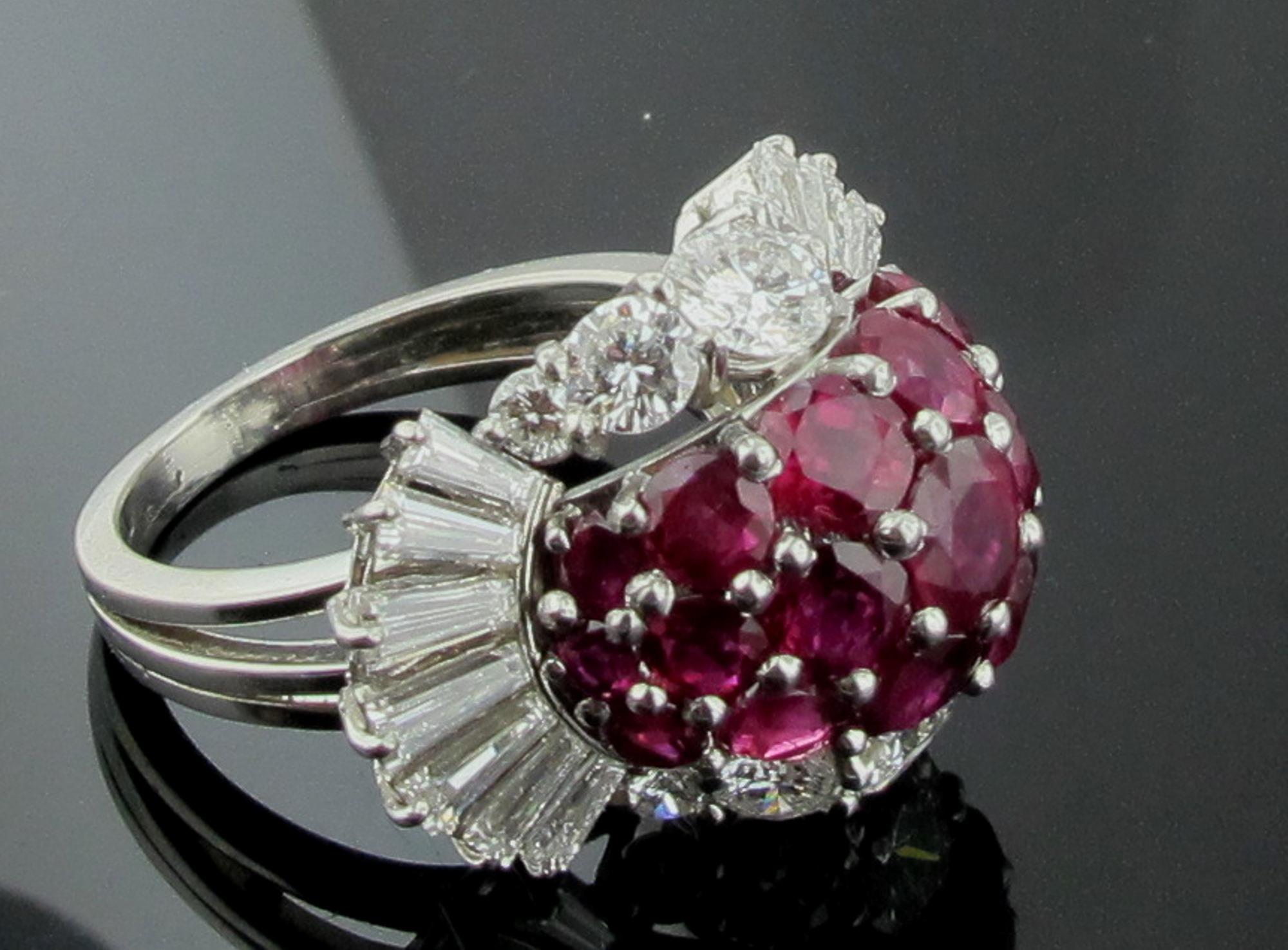 Set in white gold are 19 round cut Burmese Rubies for a weight of 5.68 carats surrounded with 14 baguette cut diamonds and 10 round brilliant cut diamonds for a total diamond weight of 3.69 carats.  Ring size is 8.
