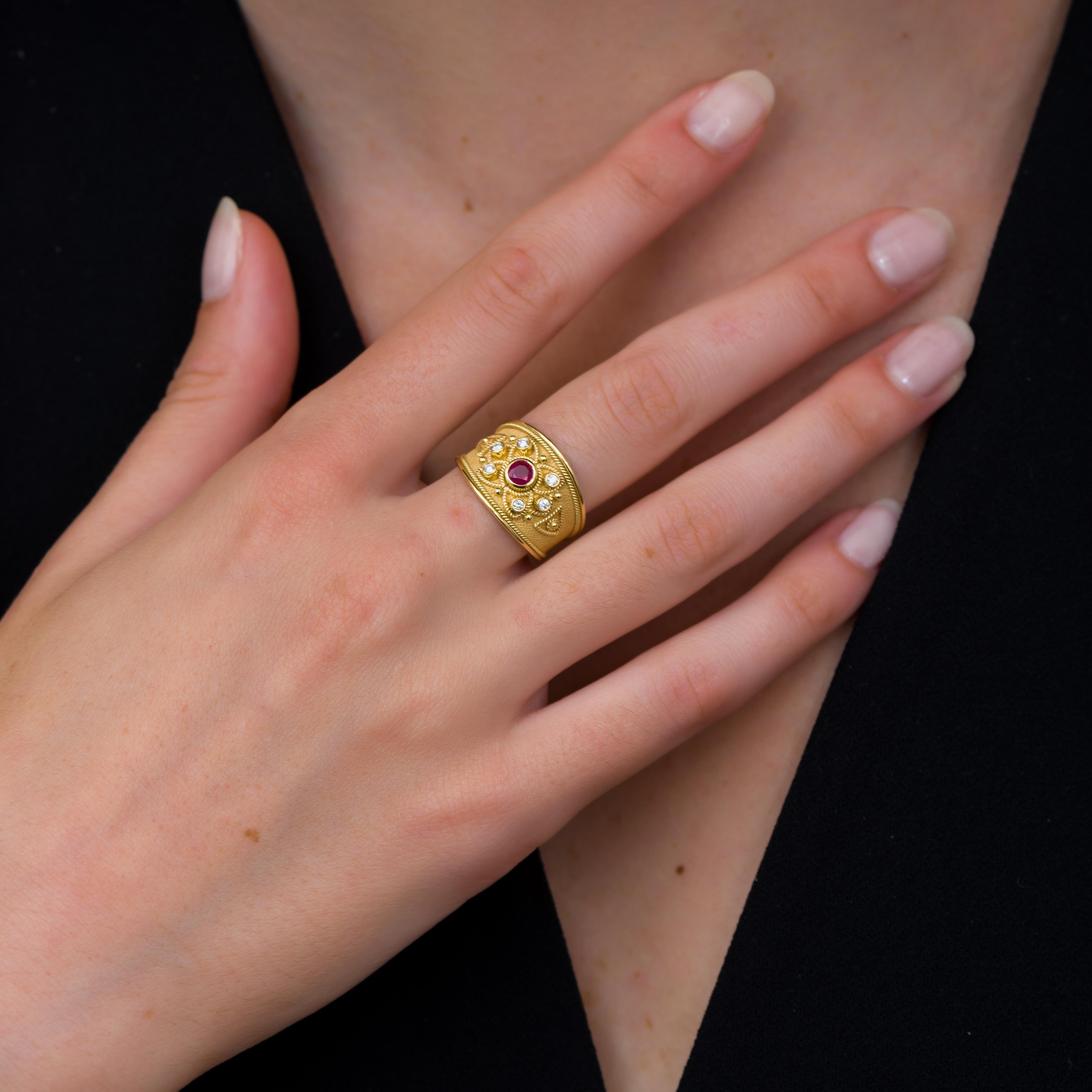 Behold our exquisite gold ring, where a pink-red ruby takes center stage, encircled by glistening diamonds. Adorned with intricate golden details, it's a masterpiece of sophistication and luxury, capturing the essence of timeless elegance and