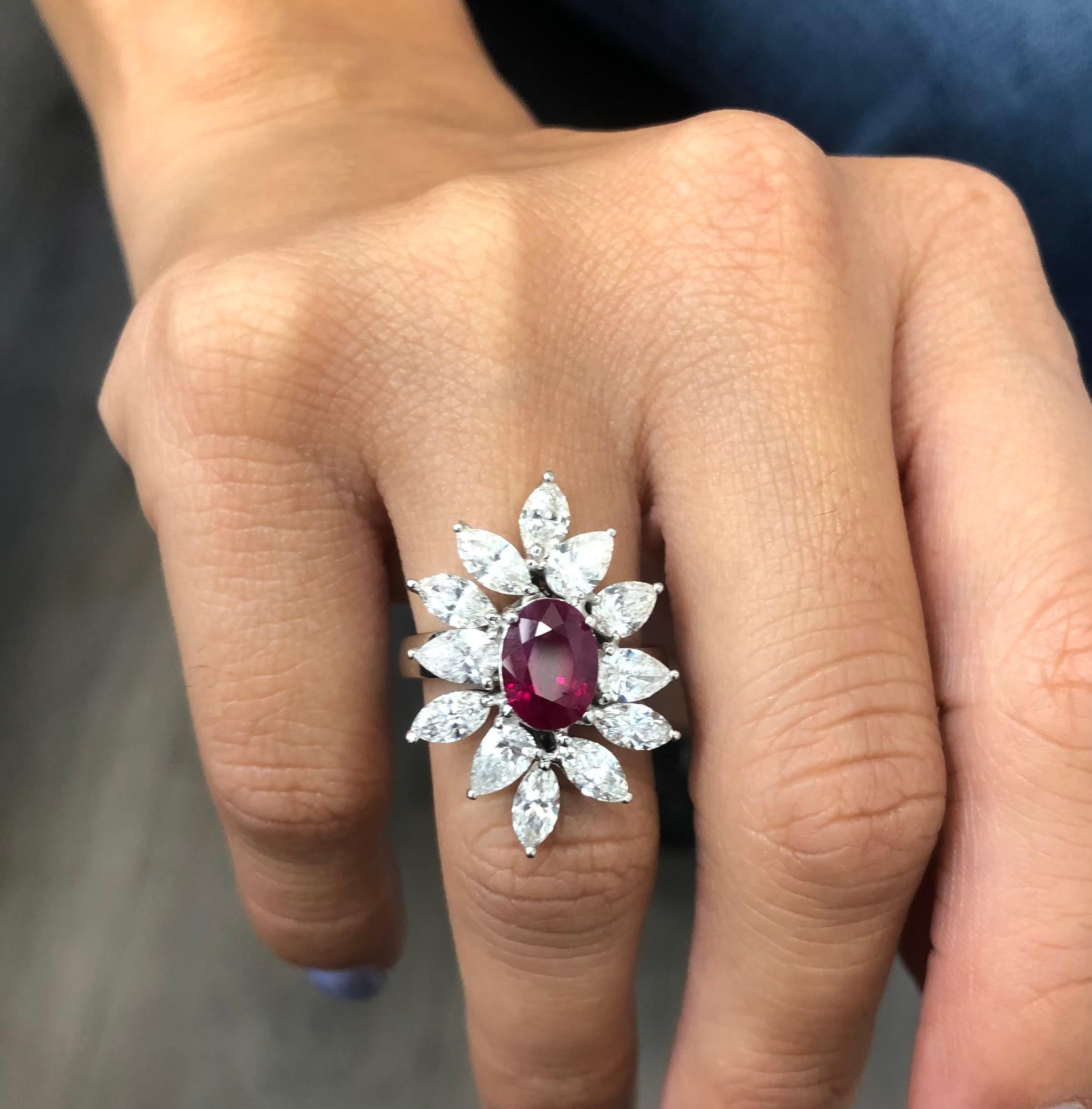 Gorgeous ring crafted in 18k white gold. This ring is real show stopper. The highlight of the ring is one 3.06 ct. oval shape natural ruby gemstone showing pigeon blood Burma ruby color. The ruby is vibrant as it is accompanied with a GRS laboratory