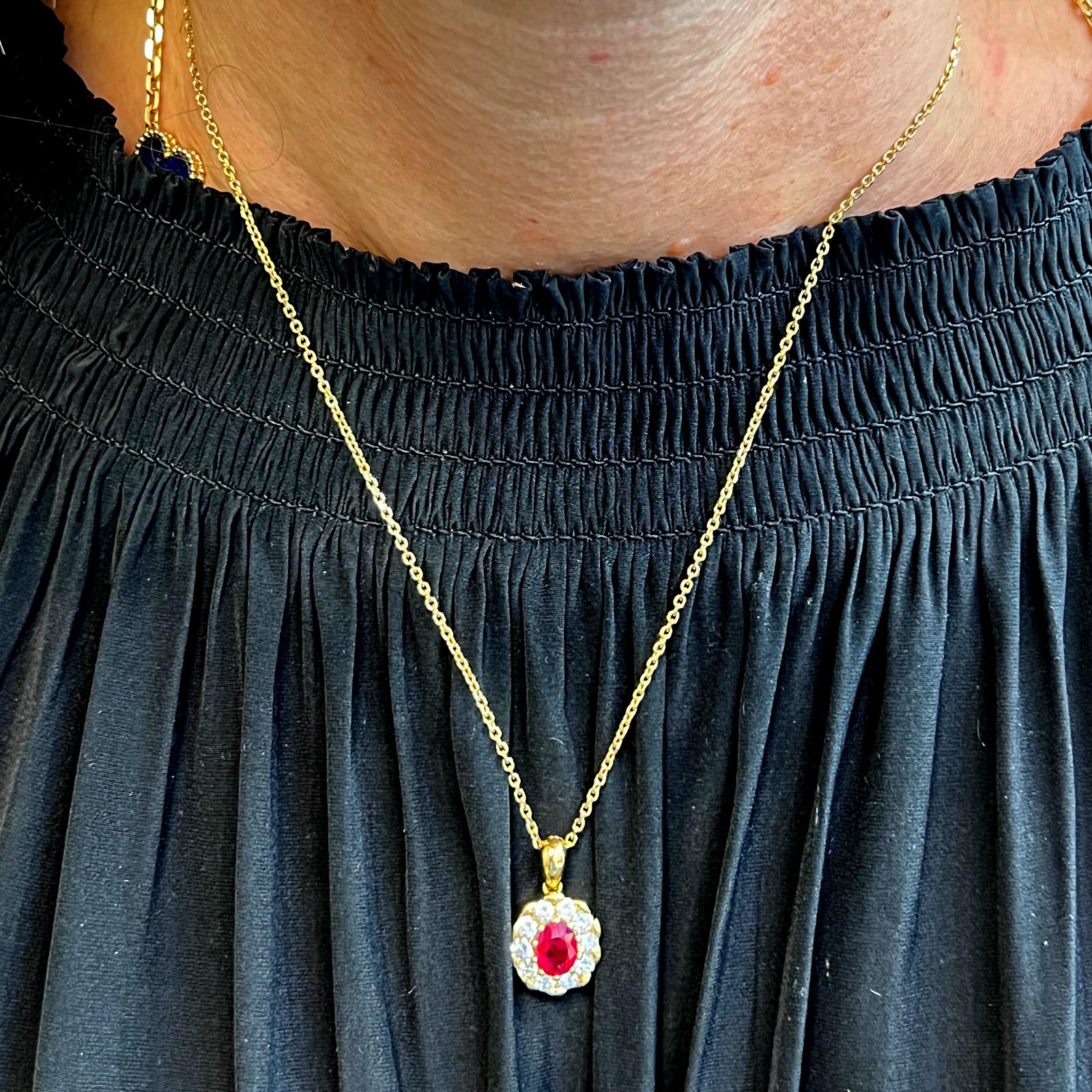 Beautiful Burma Ruby and diamond pendant crafted in 18 karat yellow gold. The oval 1.14 carat Burma ruby is certified by the AGL to be of Burma origin and to have minor heat residue. The vibrant ruby is surrounded by 10 round brilliant cut diamonds