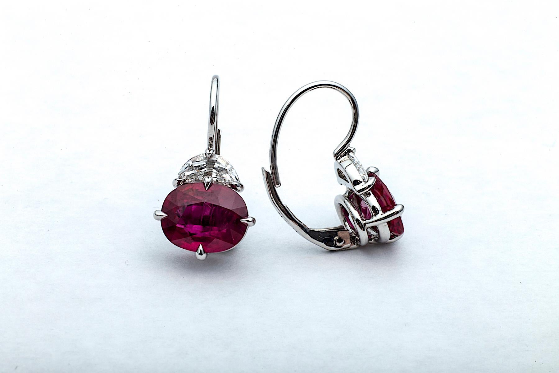 Experience the power and pop of the color red when wearing these extraordinary ruby and diamond handmade drop earrings designed by Steven Fox.  These oval cut vibrant red Burmese rubies, totaling 3.91 carats, are crowned with half moon cut diamonds,