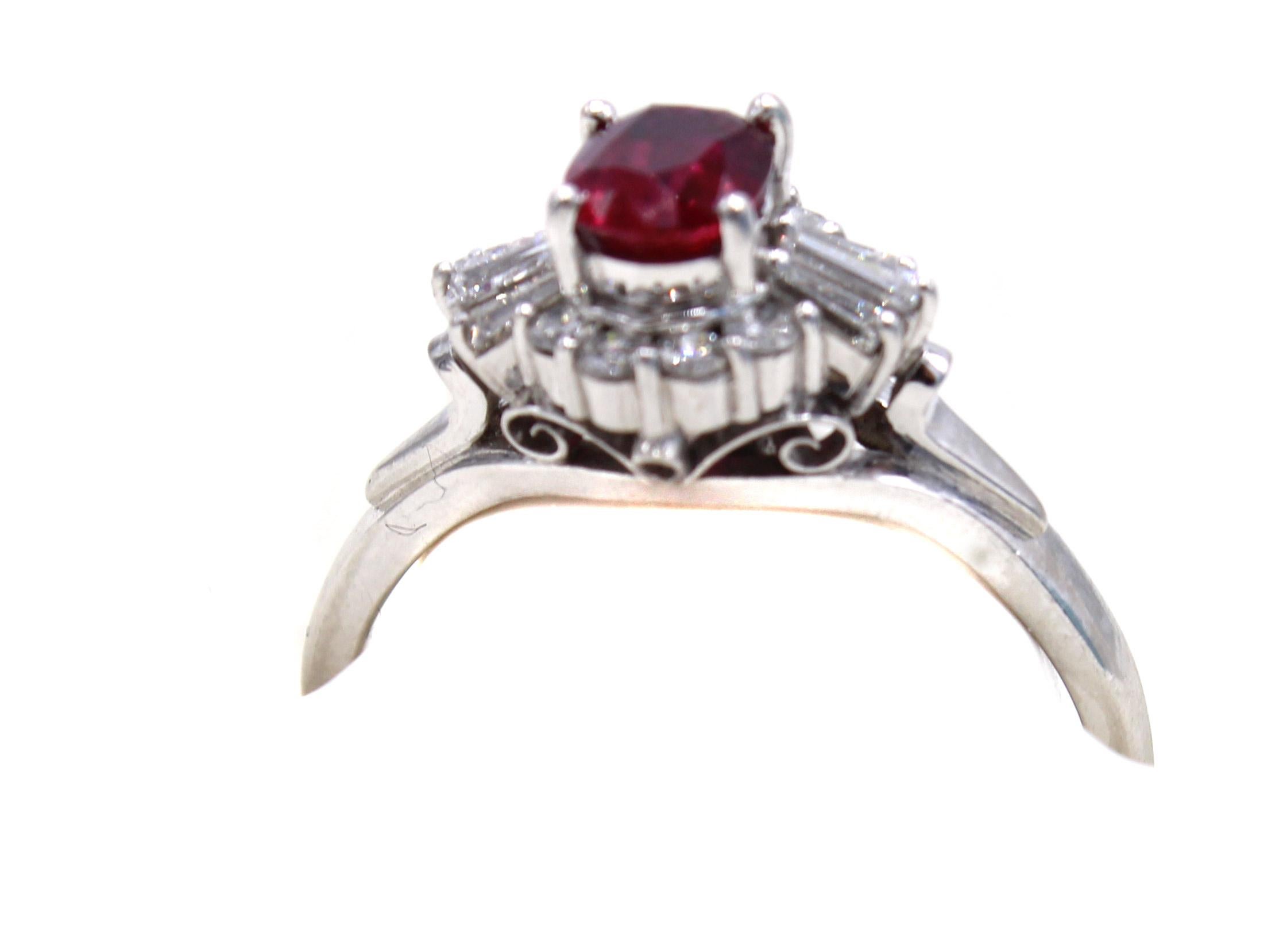 Wonderfully designed and masterfully hand-crafted this platinum engagement ring features a Pigeon Blood red Burma ruby weighing 0.85 carats. Embellishing the center gem are 8 round brilliant cut and 6 tapered baguette cut diamonds with a total