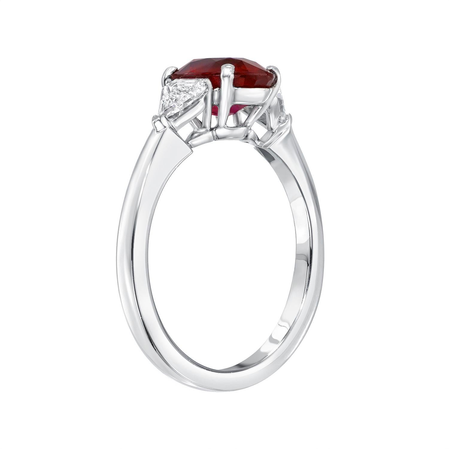 Very desirable 2.34 carat oval Burmese Ruby three-stone platinum ring, flanked by a pair of trillion diamonds weighing a total of 0.34 carats. 
Ring size 6.5. Resizing is complementary upon request.
Crafted by extremely skilled hands in the