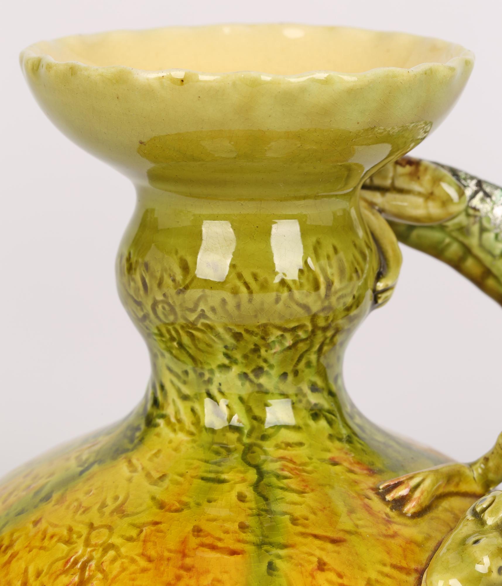 A rare Burmantofts Faience pottery chamberstick with a grotesque alligator modelled handle dating from 1880’s. The chamberstick has a wide round domed base with a pinched column stem and fluted edged bowl-shaped top with integral candleholder. The