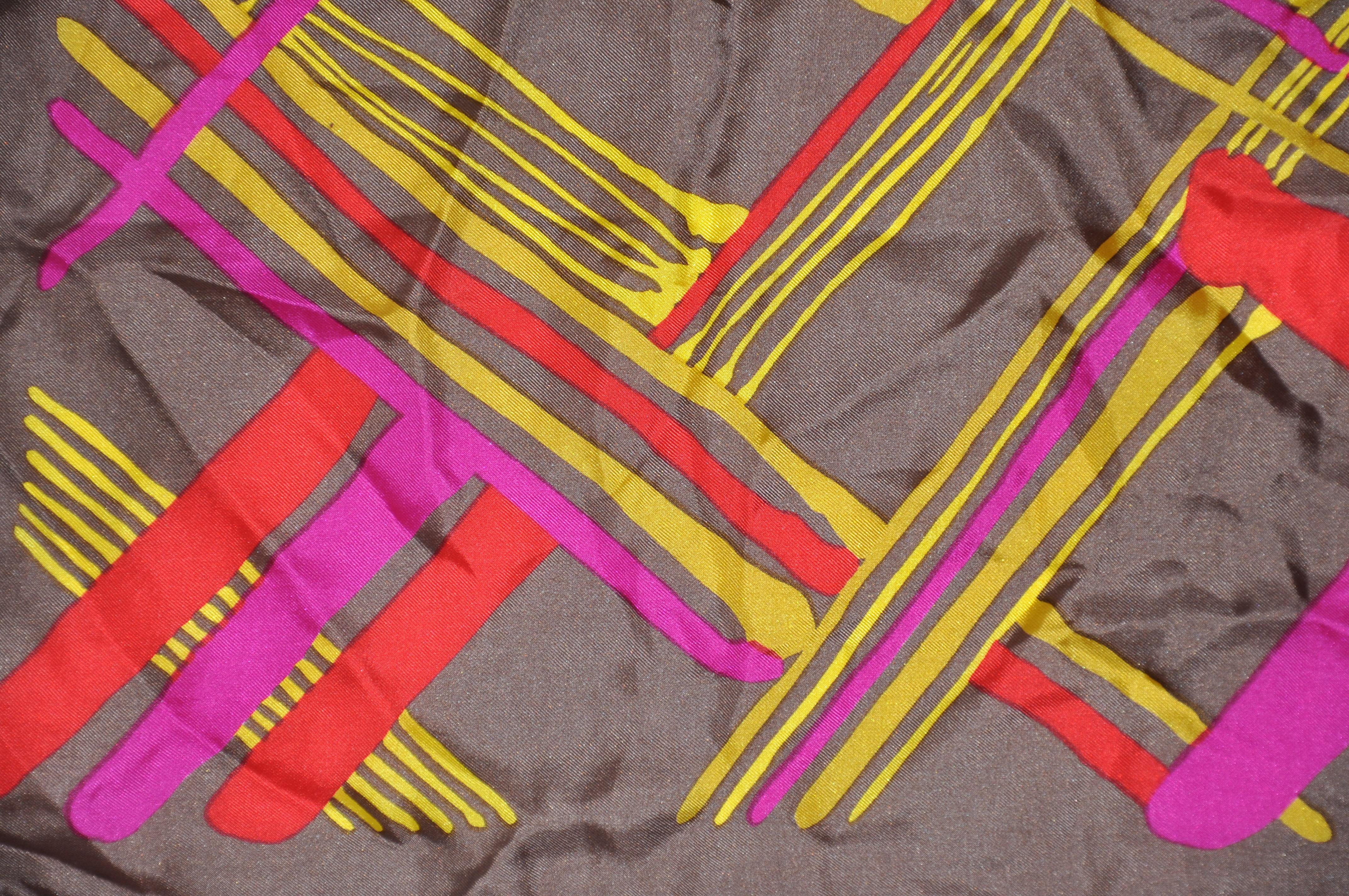      El maravilloso pañuelo de seda multicolor a cuadros escoceses de Burmel, acentuado con bordes rojos enrollados a mano, mide 26 pulgadas por 26 pulgadas. Fabricado en Japón.