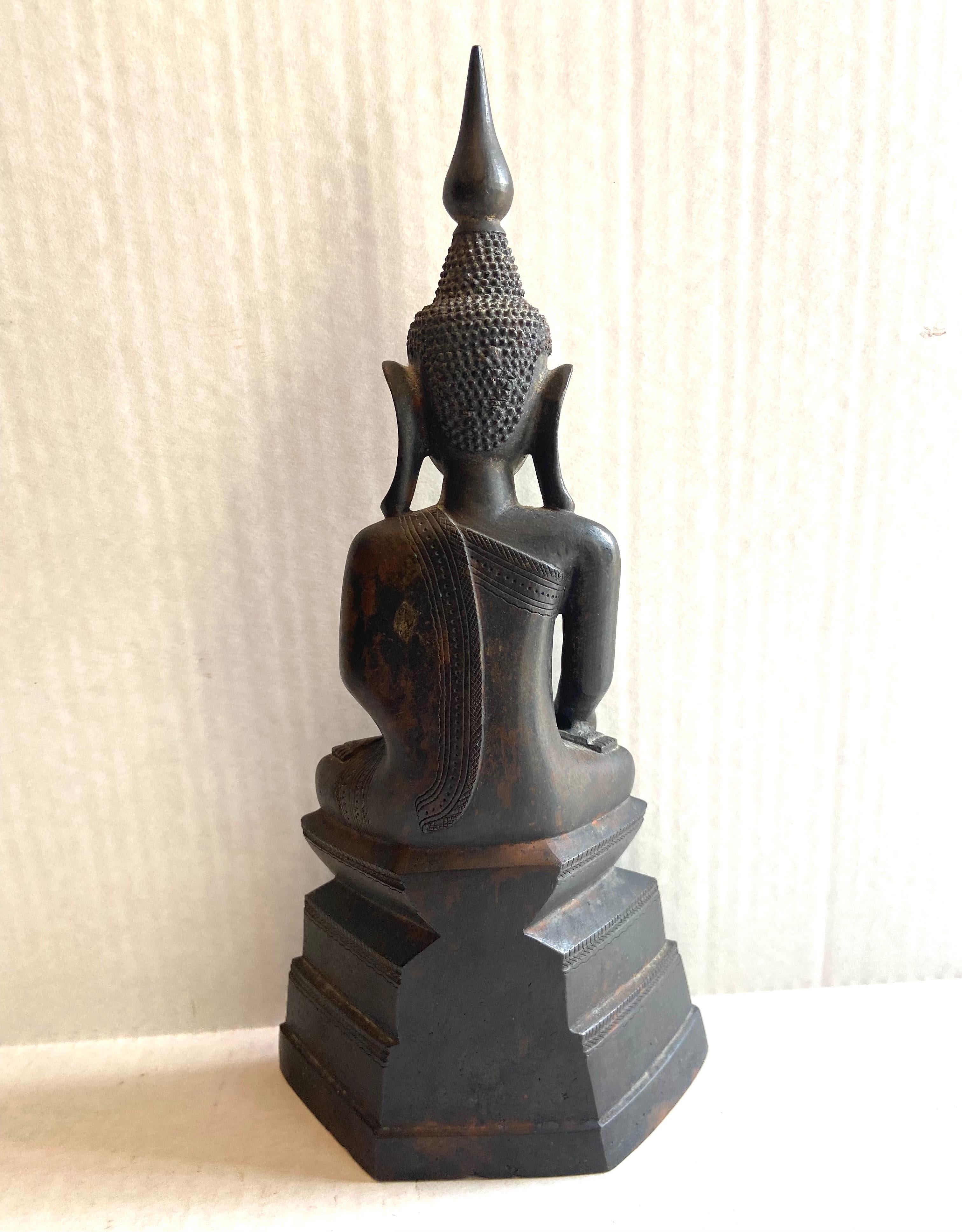 Burmese 18th Century Bronze Shan Buddha. This Buddha is placed in temples and at stupas as objects of commemoration and devotion. He holds his right hand downward in the earth-touching gesture (bhumisparsha mudra) with which he calls the earth
