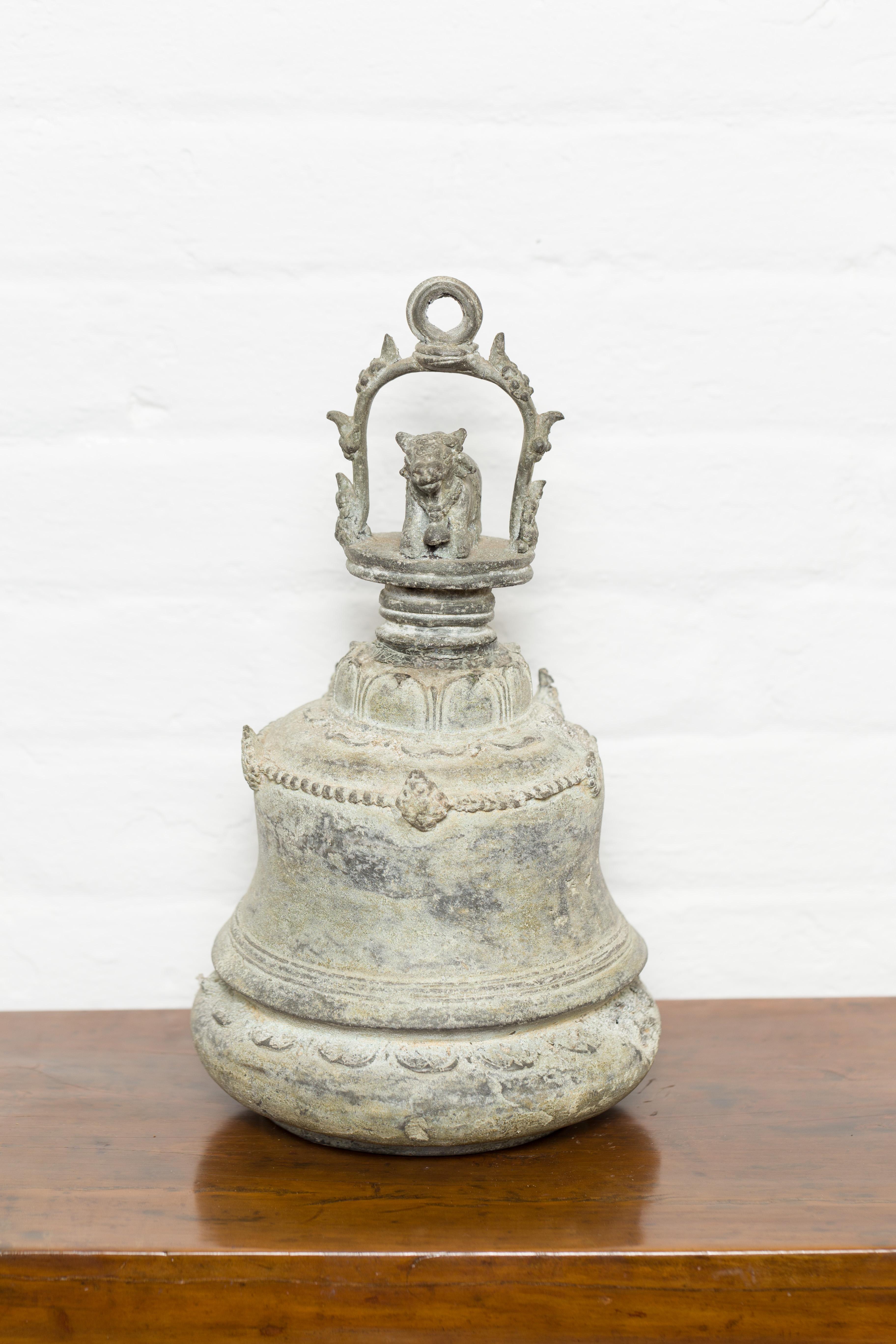 An antique Burmese bronze ceremonial bell from the 19th century with verde patina and cow motif. Created in Burma during the 19th century, this bronze ceremonial bell will make for an excellent decorative object. Boasting a verde patina with nicely