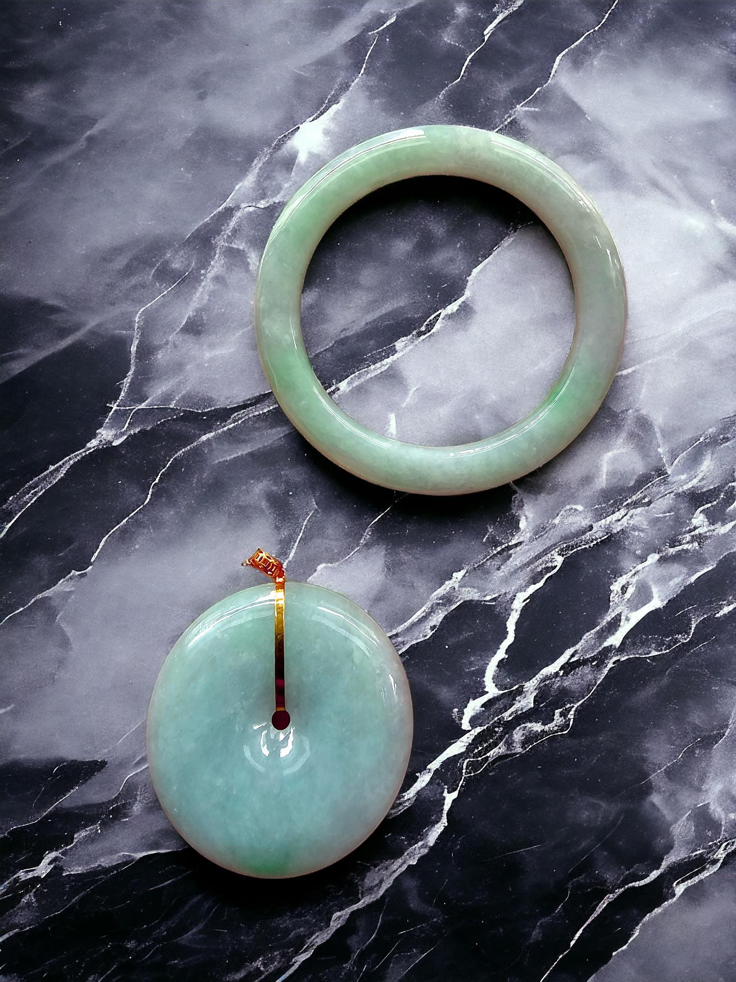 Just like how a mother forms the center and nucleus of a child, we created the 'Opulent Offspring Burmese Jade Set' with a Donut Shaped Pendant and a Baby's Bangle from the same rough block of Burmese A-Jadeite. 

This set of a pendant for the