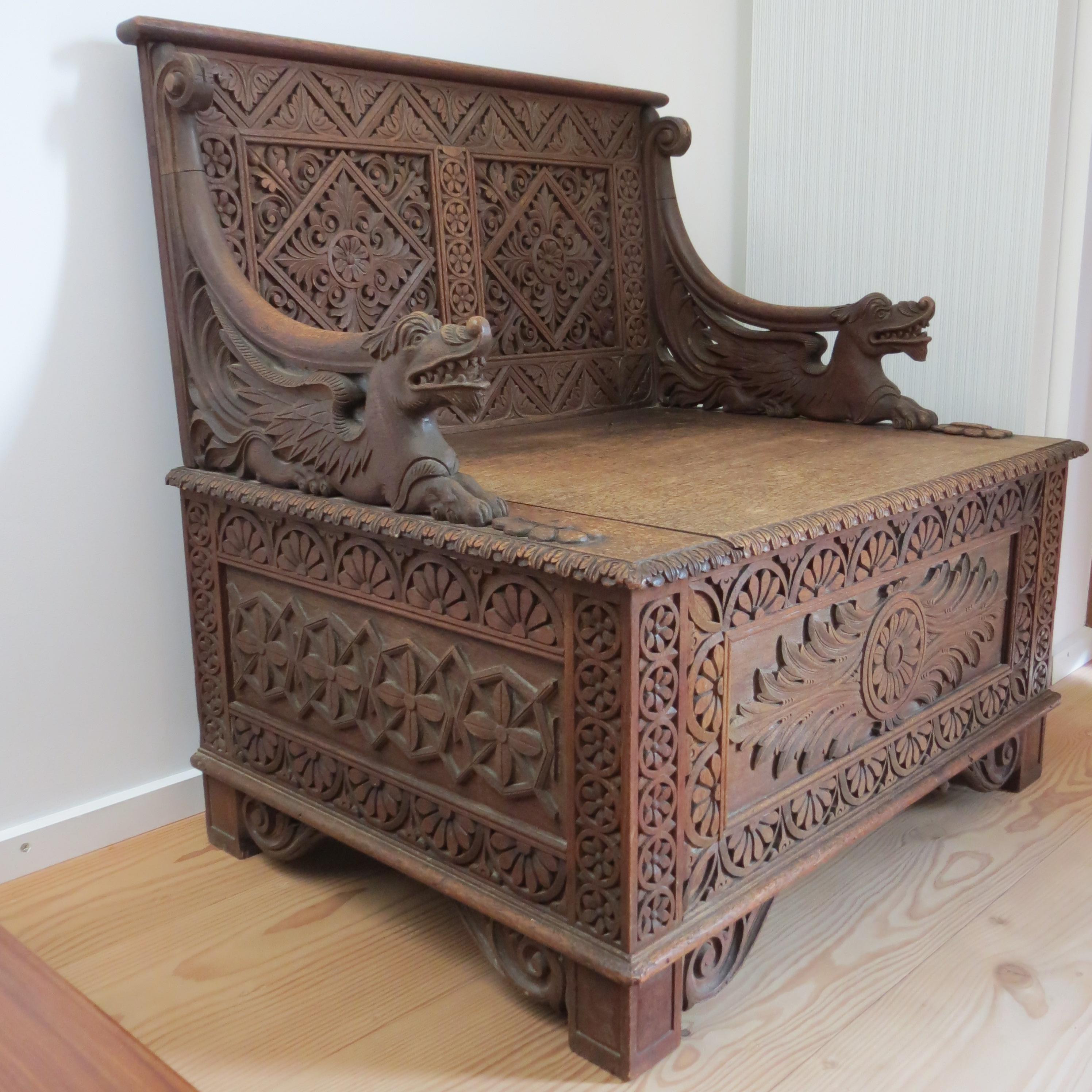 Wonderful 19th century antique Anglo- Indian Burmese carved hall seat from the 19th Century.  Made from solid Teak, exquisite carving, this piece would have been made in Burma for the English market. 
Two dragons sit as arms either side and a hinged