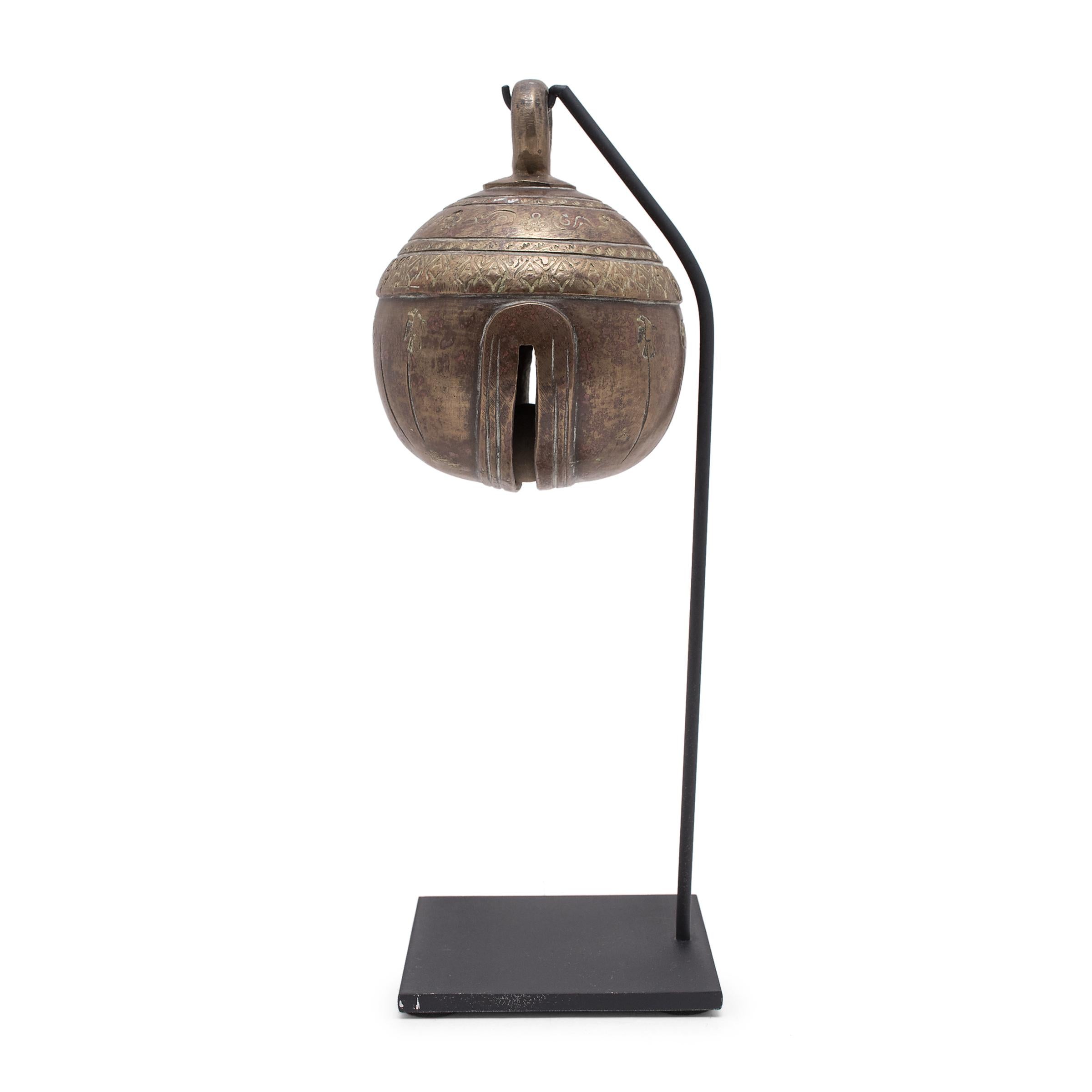 Known as chu, this large bronze bell was crafted in Burma and was used to track the movement of livestock. This distinctive spherical form was mostly worn by elephants so that they could be located after being set free to forage. Dated to the 19th
