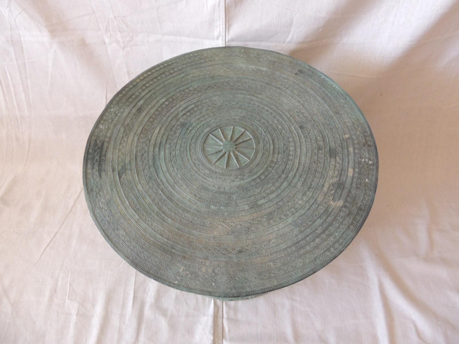 Burmese bronze Karen rain drum with intricate decoration on the top and around the body of the drum with four two handles on each side. These drums are also referred to as frog drums and have been used for hundreds of years in various tribal rituals