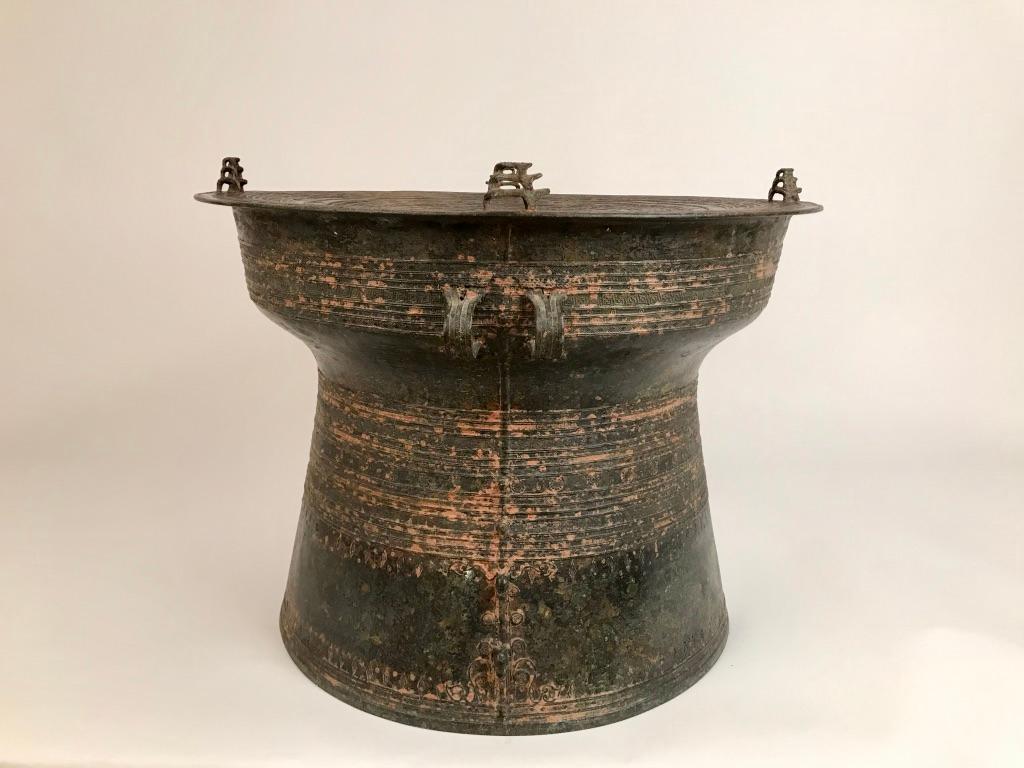 Burmese bronze Karen rain drum with intricate decoration on the top and around the body of the drum with four triple piggy-backed frogs on the Tympanum and elephants in relief on one side. These drums are also referred to as frog drums and have been