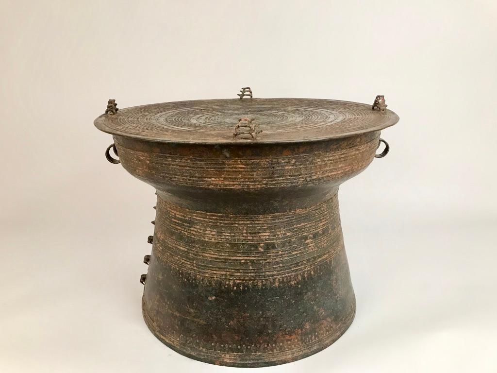 Burmese bronze Karen rain drum with intricate decoration on the top and around the body of the drum with four triple piggy-backed frogs on the Tympanum three elephants in relief on one side. These drums are also referred to as frog drums and have