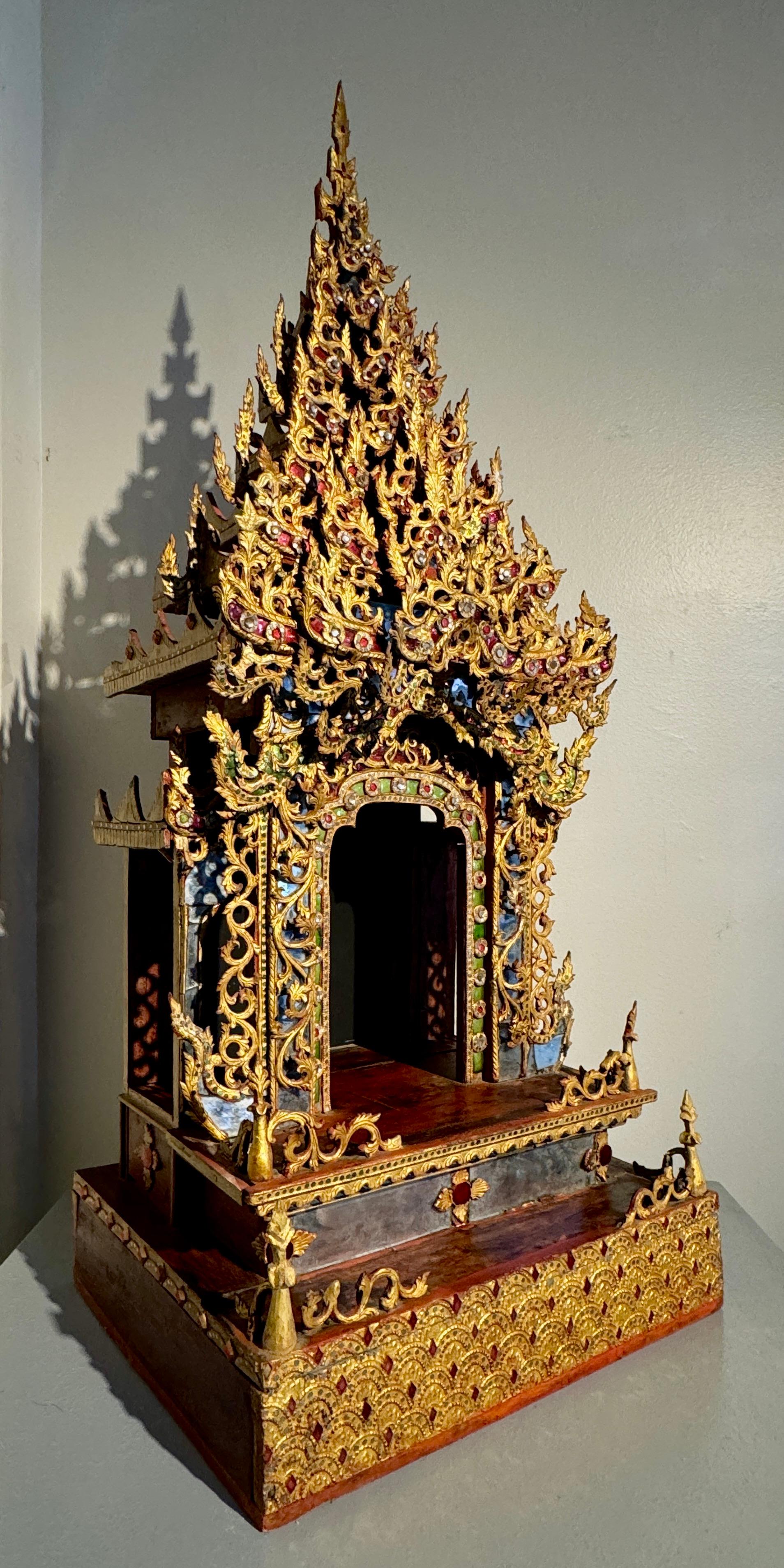 A large and magnificent Burmese gilt and embellished throne or shrine for a Buddha, palin, Mandalay Period, last half of the 19th century, Burma (Myanmar).

The impressive throne structure in two parts, the main shrine, and the tall, stepped pagoda