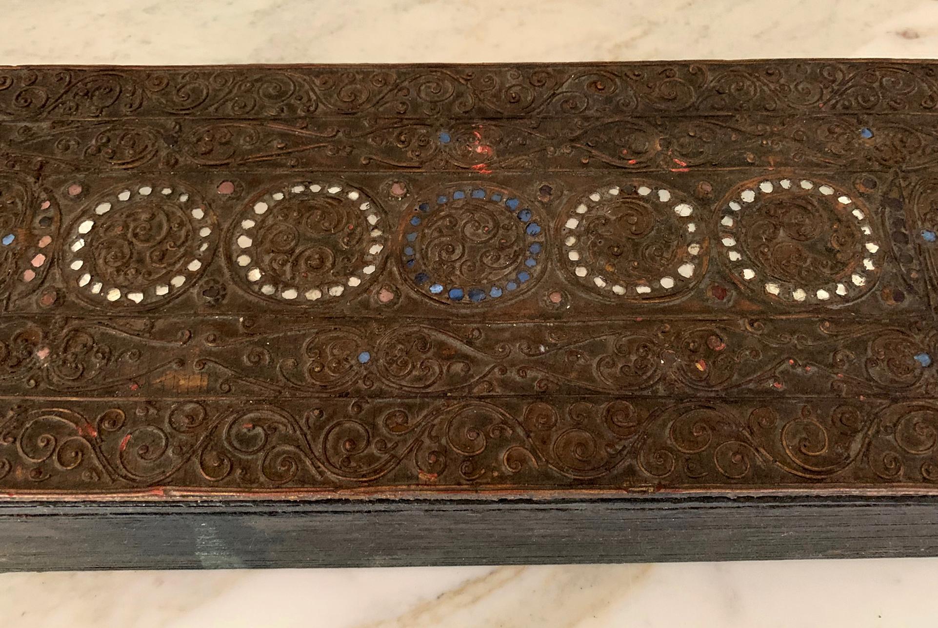 A large Theravada Buddhism scripture book from Burma, circa late 19th century-early 20th century. The book opens to continuous folding pages that is accordion like. Ink scriptures in curvy Burmese language were handwritten on both sides of the