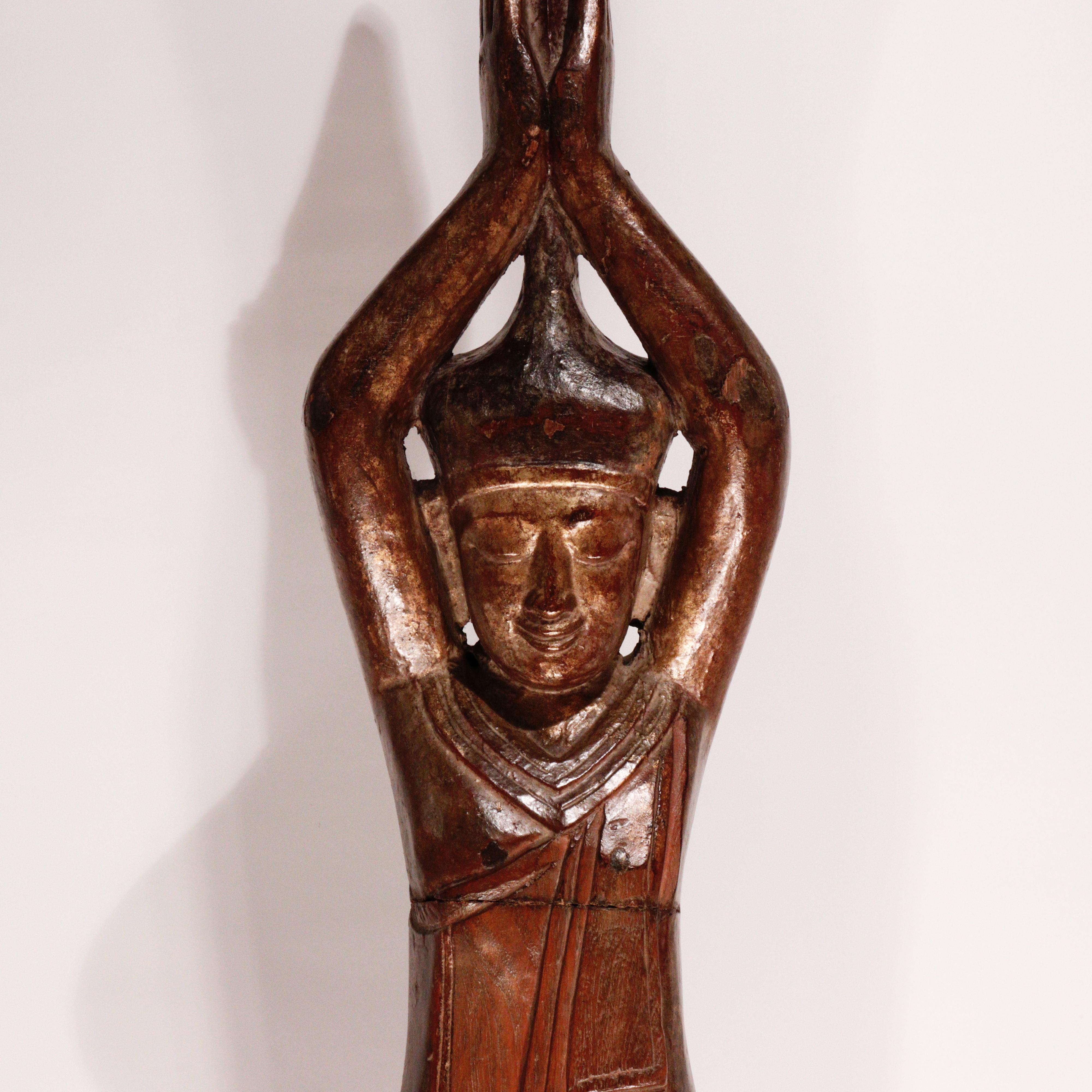 Burmese carved solid wood image of the Hermit Sumedha, known for lying down and stretching his body thin before the Dipankara Buddha, using his body as a bridge so that the Buddha would not have to walk in the mud and who in turn prophesied that