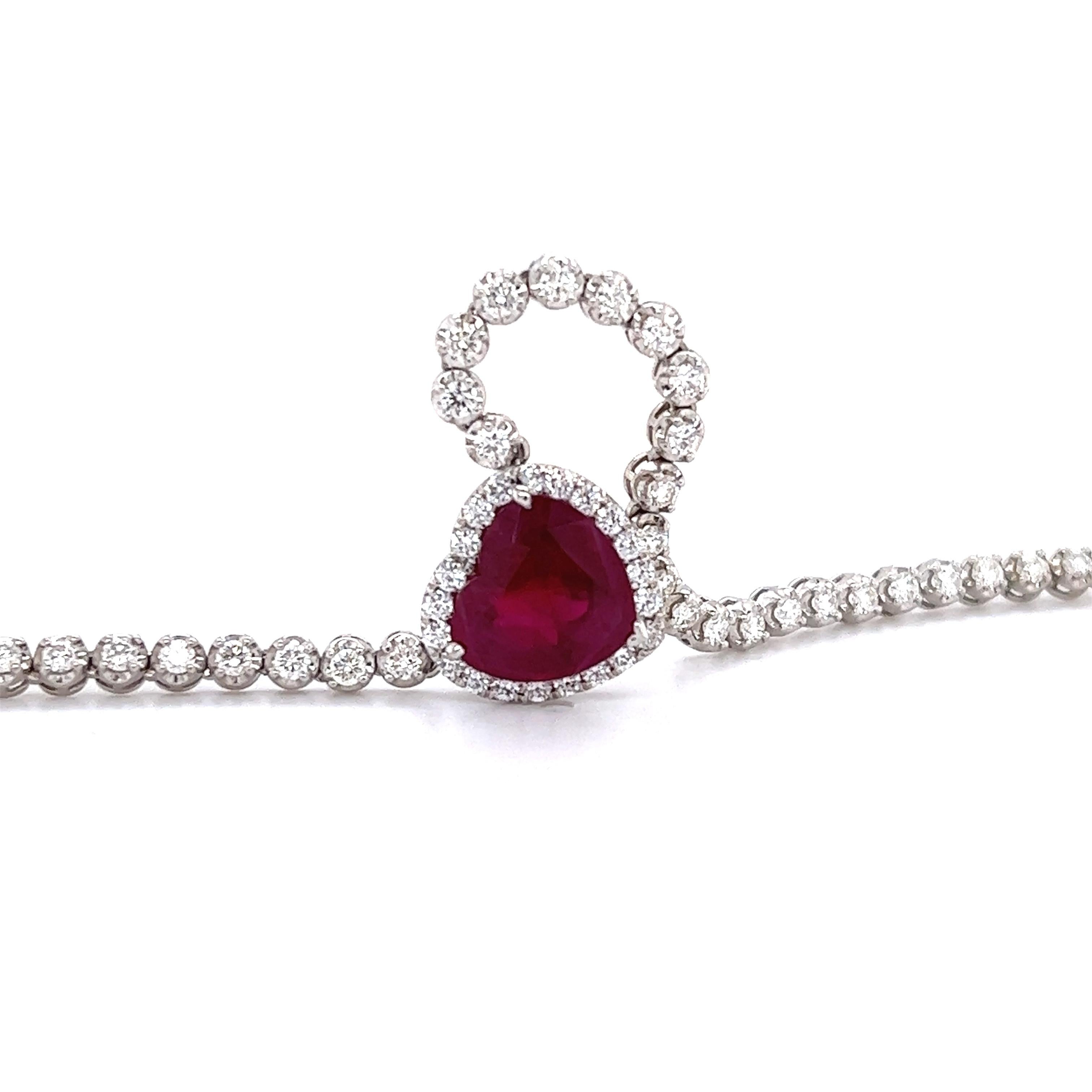 Beautiful designed diamond necklace crafted in 14k white gold. The necklace highlights one 4.76 ct. Burmese ruby in a heart shape. Burma Rubies are the rarest and most valuable member of the corundum family. Colors range from pink red ruby to a
