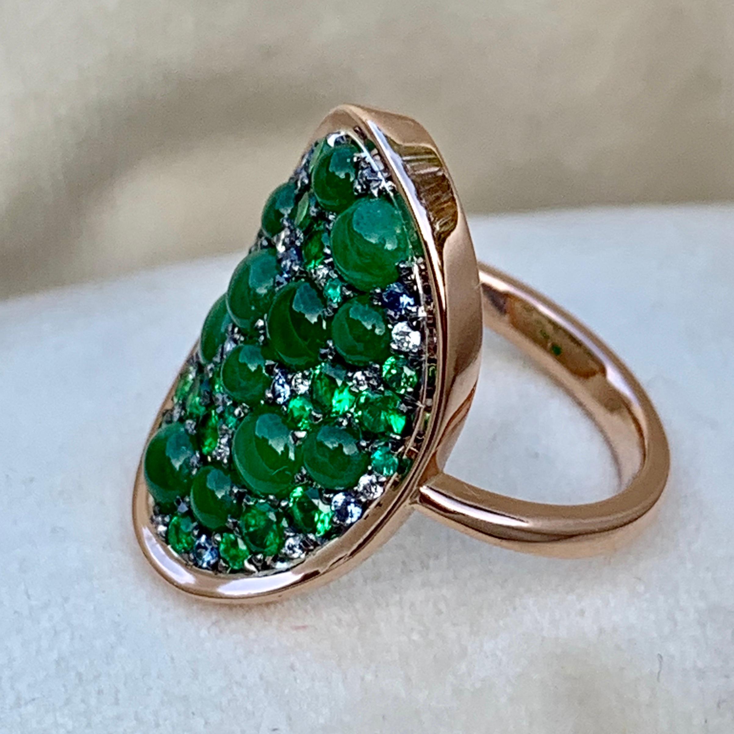 One of a kind handmade ring in 18K Rose gold 6,4 g & blackened sterling silver (The stones are set on silver to create a black background for the stones)
Pave set with natural & untreated translucent Burmese Jadeite cabochons, Tsavorite 0,86 ct.,