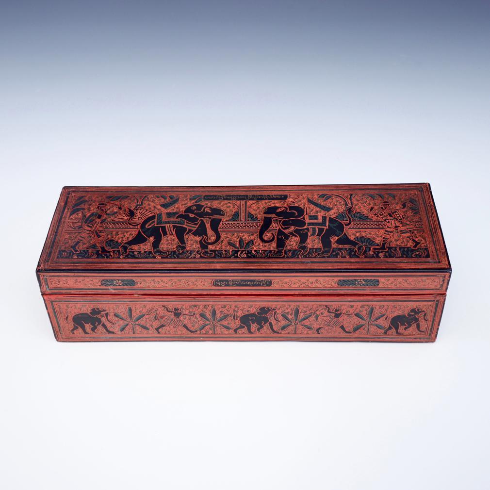 Antique Burmese Lacquer Rectangular Box with Incised Decoration of Elephants and Figures. The box crafted of wood and covered in several layers of black, orange, green and yellow lacquer. The design of elephants and mahouts on a leafy foliate