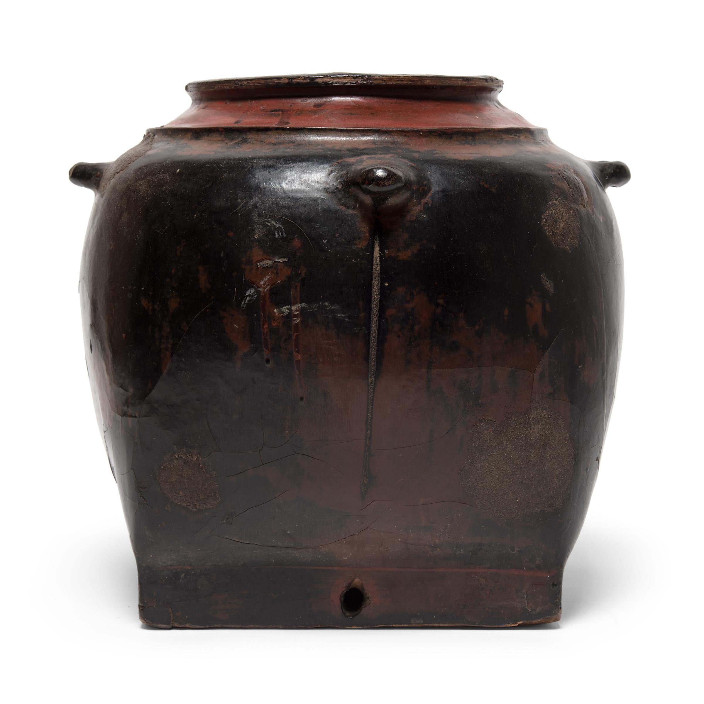 This round Burmese vessel was likely designed as hanging storage for everyday use. A thin core structure of wood and clay was then cloaked in black and red cinnabar lacquer for stability and decoration. The remarkably lightweight vessel is wonderful
