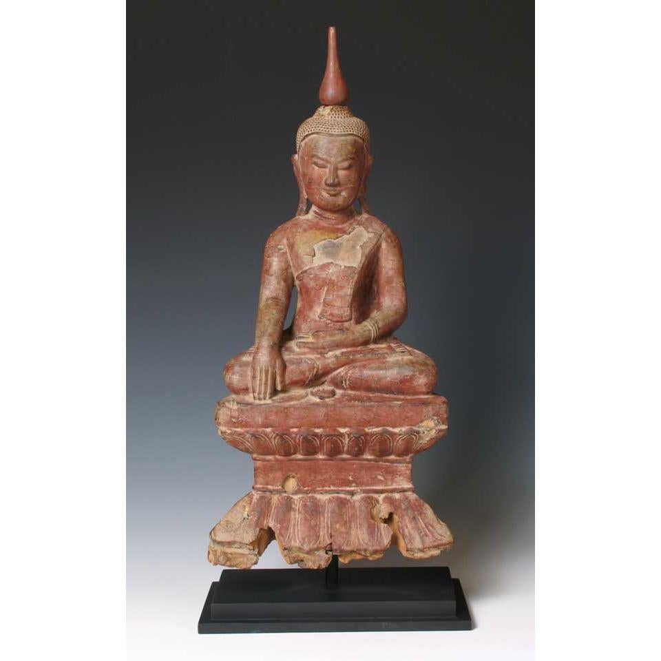 Burmese lacquered wood Buddha image, seated in padmasana, the interlocking lotus position on a waisted lotus style base with the right hand in the bhumisparsa mudra (the earth touching position) and the left hand open resting in the lap, a sublime