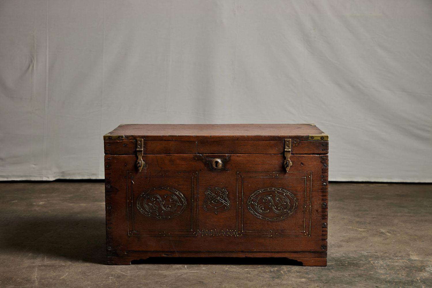 A Burmese ladies' teak make up trunk, inlaid with brass. The words 