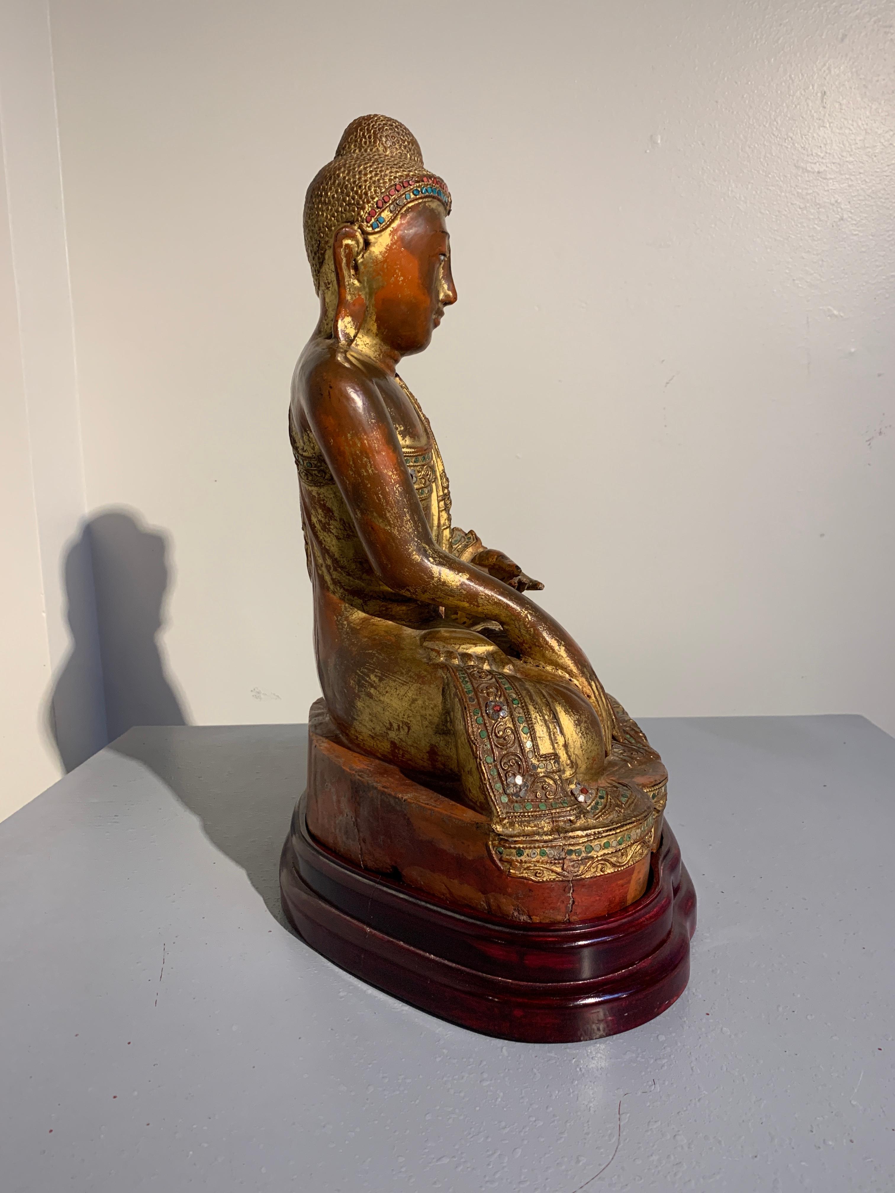 Shell Burmese Mandalay Period Red Lacquered, Gilt and Embellished Buddha, 19th Century